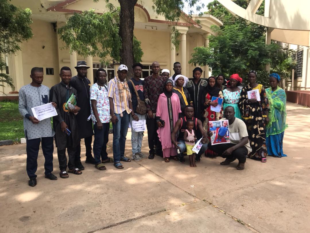Parents of killed Gambian children pose for a photo at a meeting