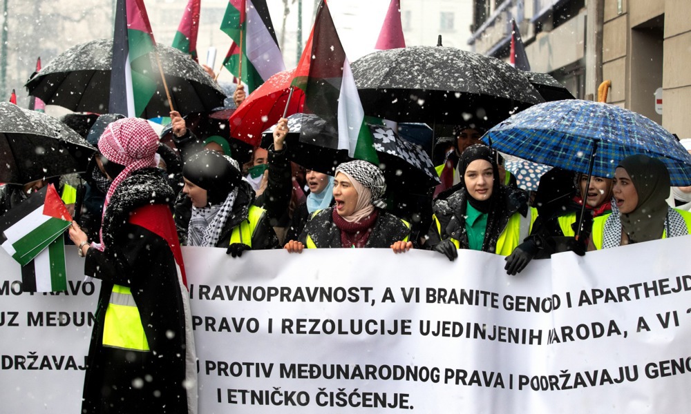 Protesters hold banners and Palestinian flags during a rally in support of the Palestinian people in Sarajevo, Bosnia and Herzegovina.
