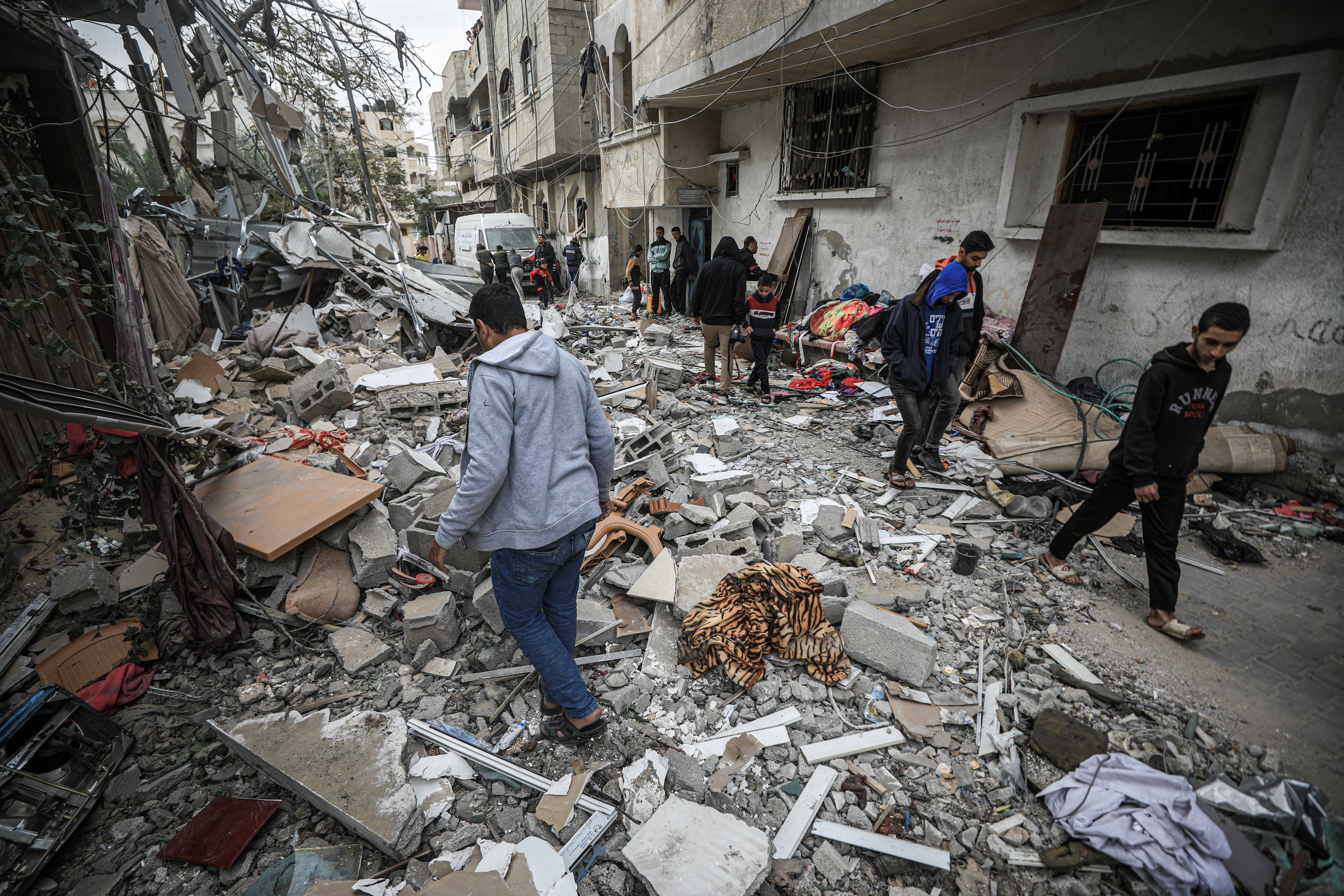 Residents checking the rubble of Khalifa family home that was bombed earlier on Friday