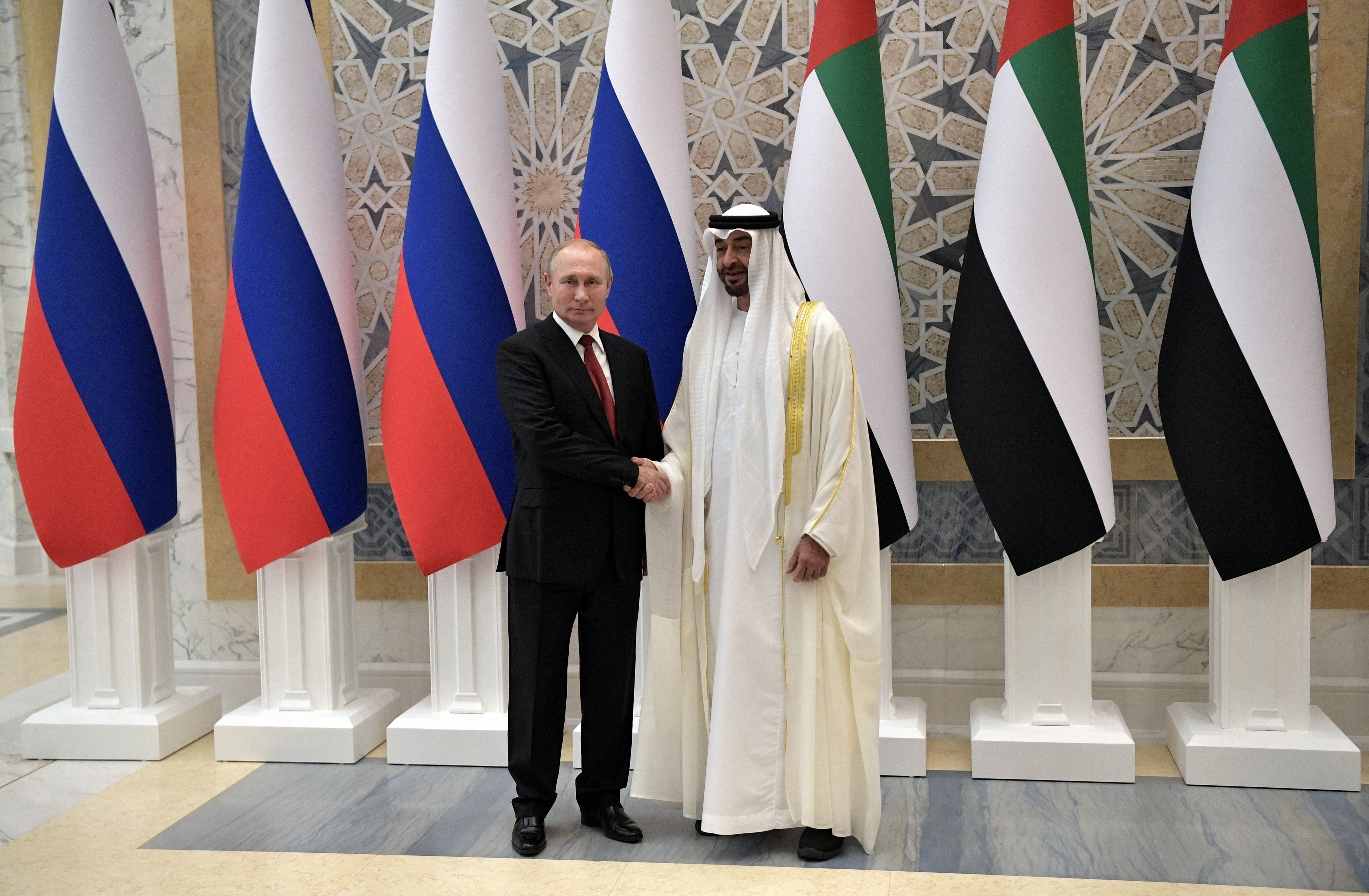 Russian President Vladimir Putin and Abu Dhabi Crown Prince Mohamed bin Zayed al-Nahyan shake hands in Abu Dhabi