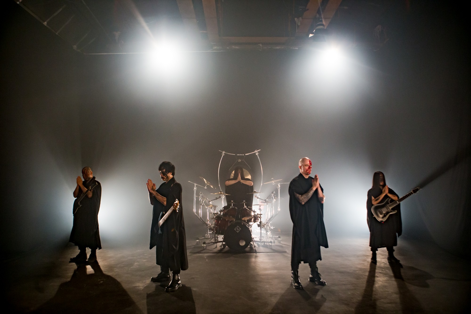 The five members of Dharma pray on stage before their performance