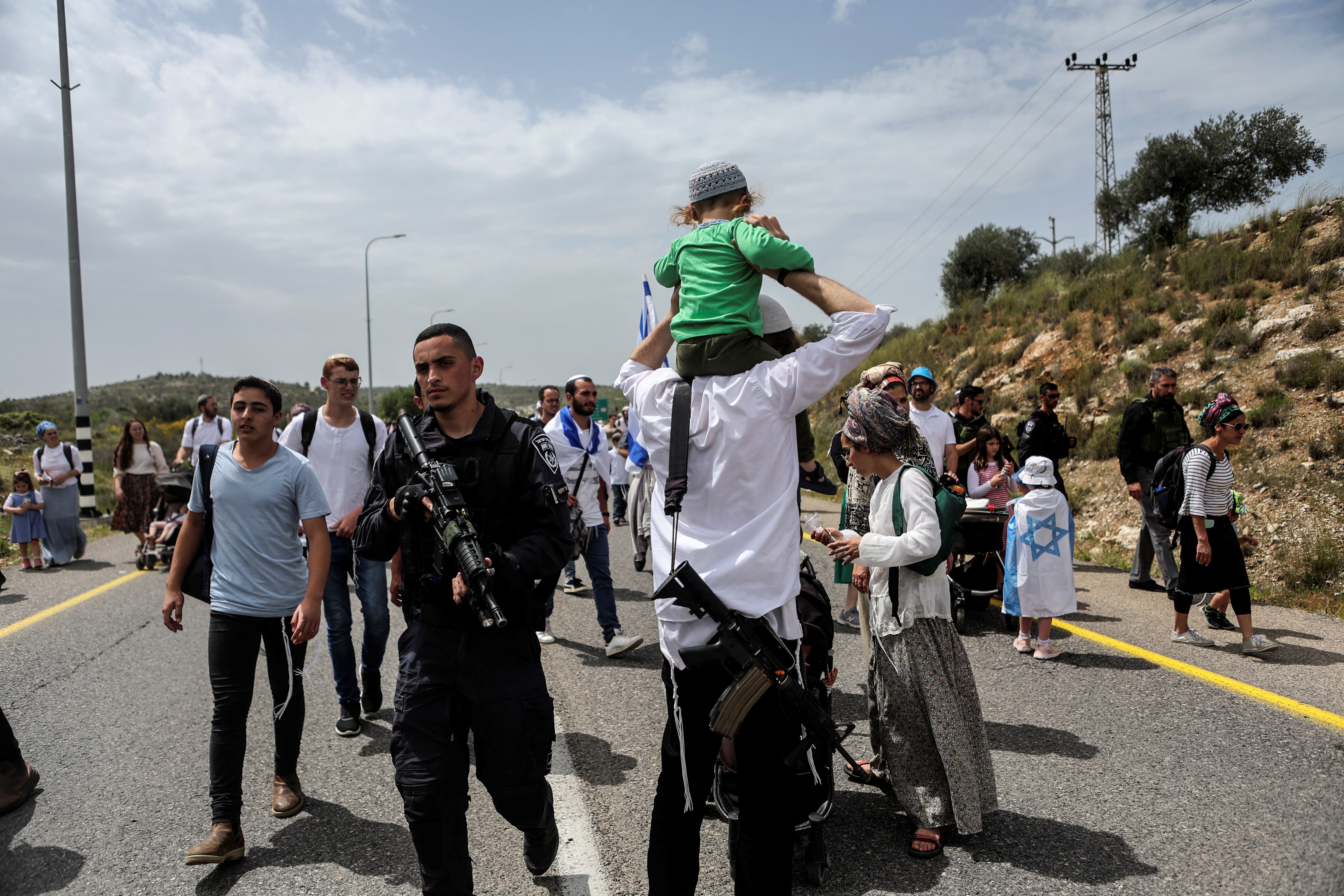Israeli settlers hold a protest march