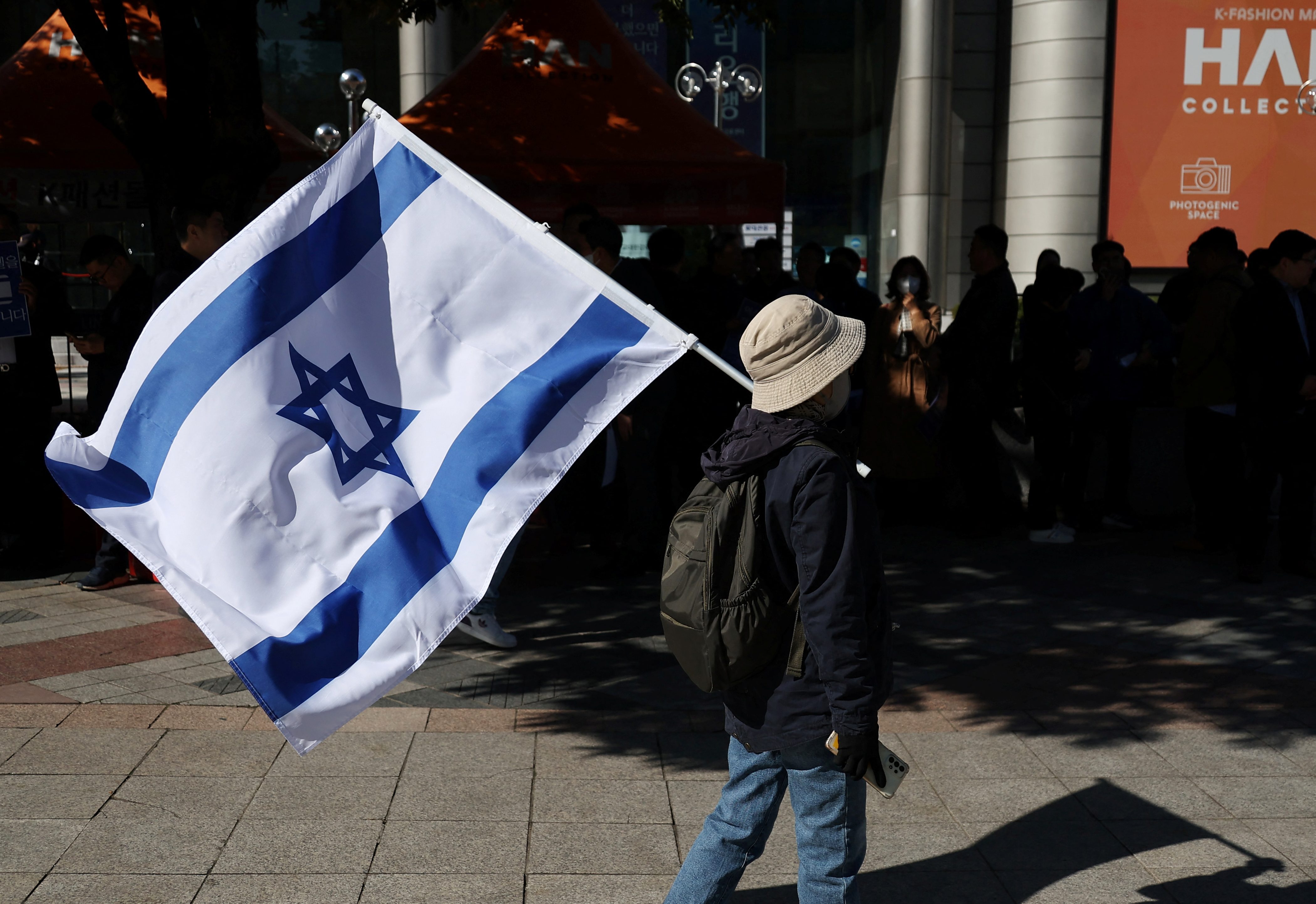 A South Korean woman holds an Israeli flag