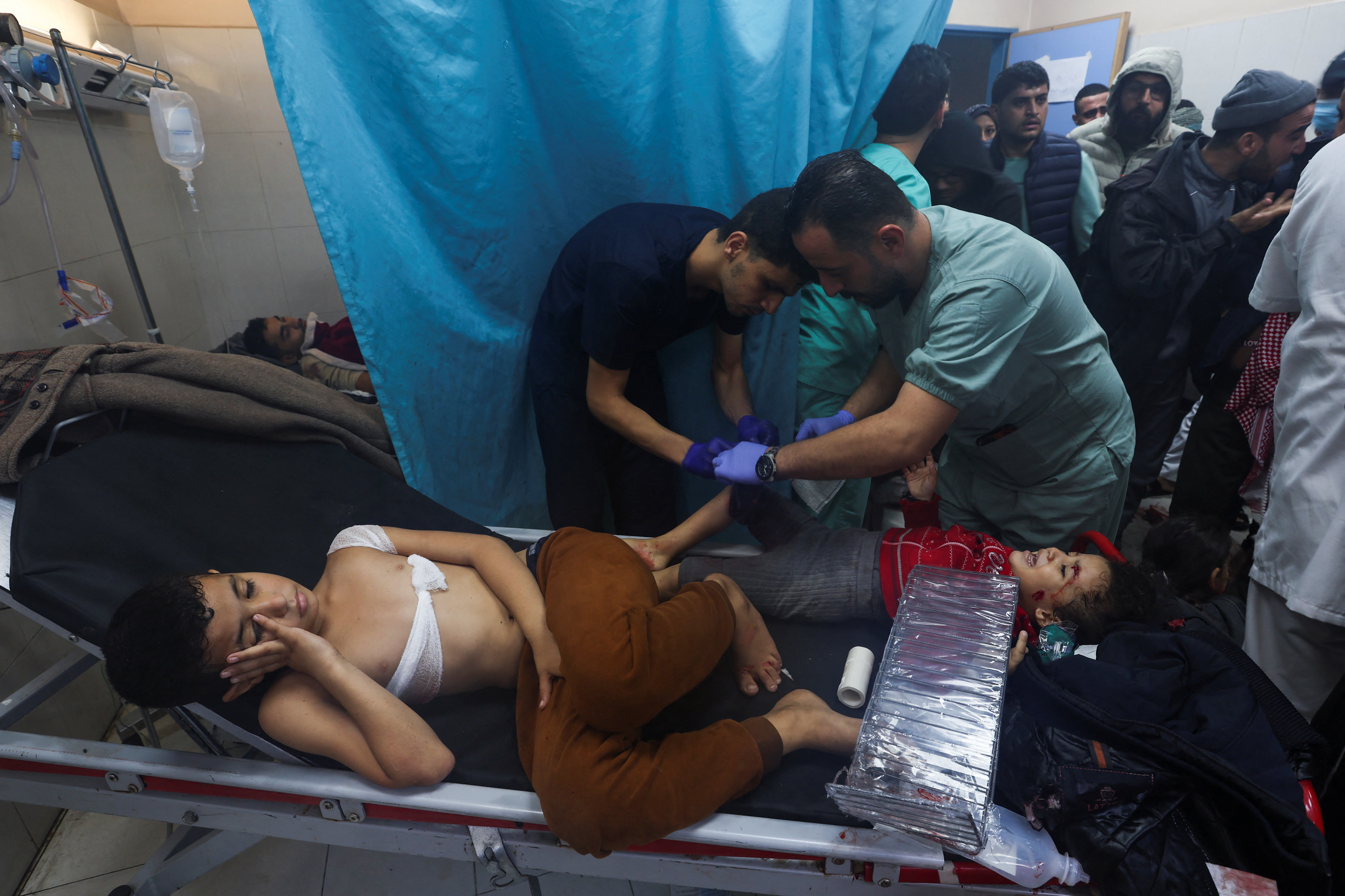 A wounded Palestinian child is assisted at Nasser hospital