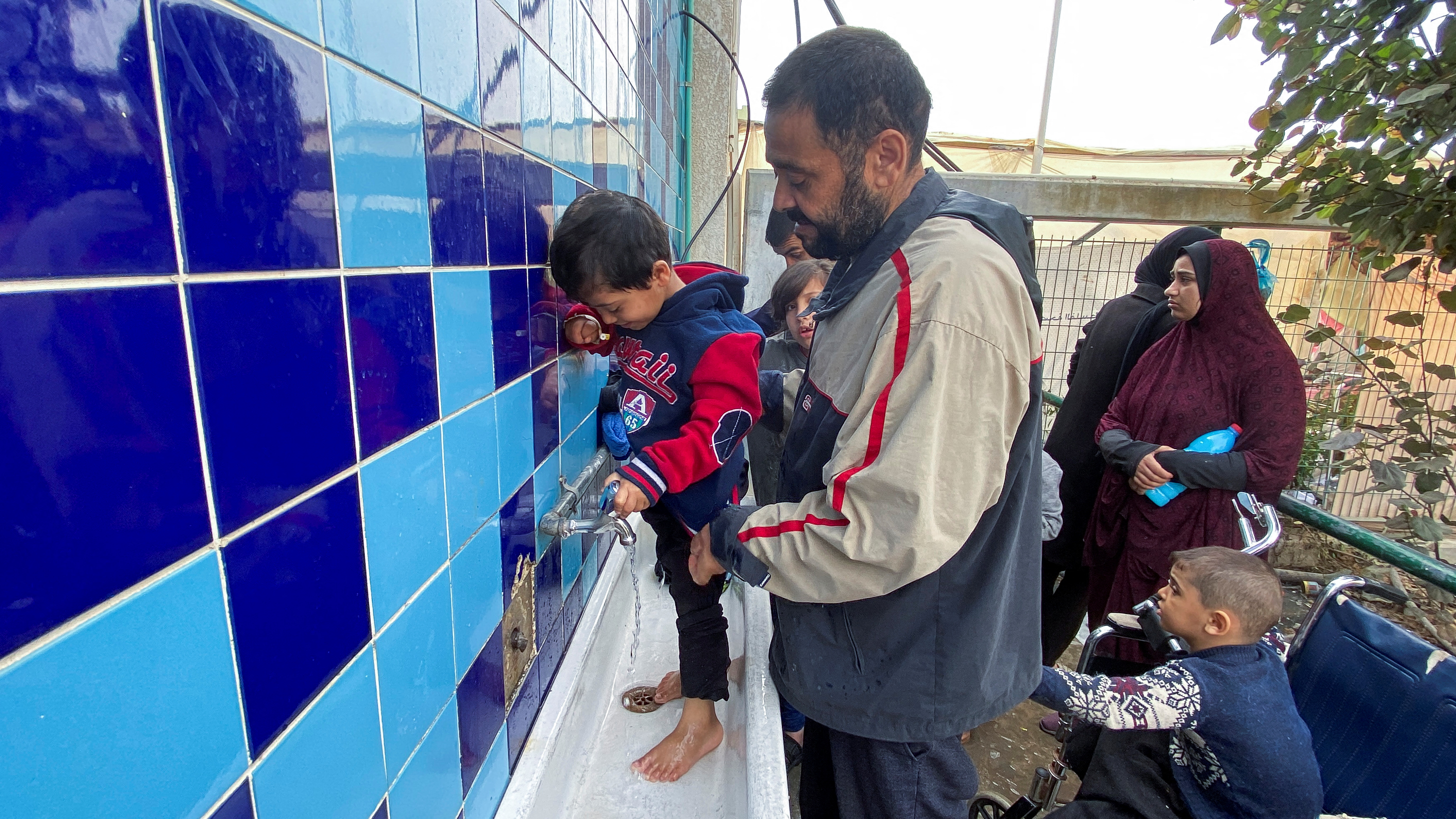 Mosab al-Kahlout, a Palestinian man whose wife and daughter were killed when their home in the Jabalia refugee camp was bombarded in Israeli strikes and has been left alone to care for his two injured sons Bara and Saad