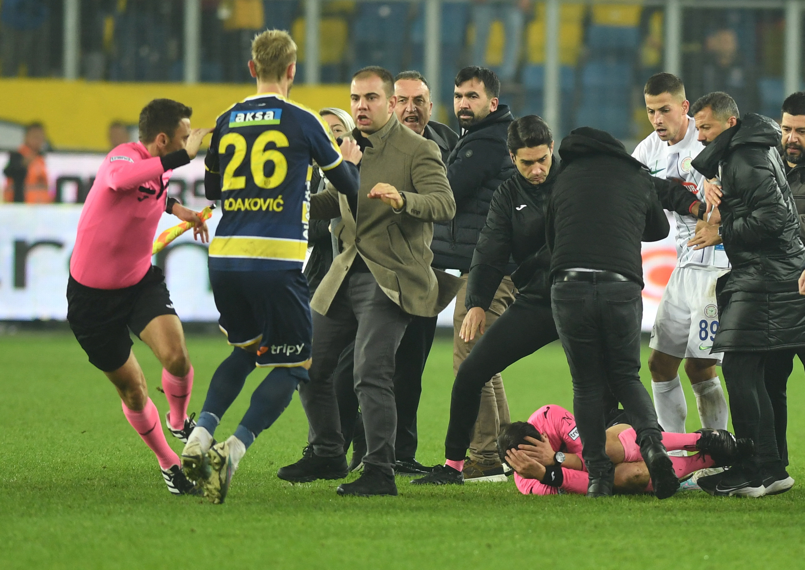 Referee Halil Umut Meler lies on the ground after being hit by Ankaragucu president Faruk Koca