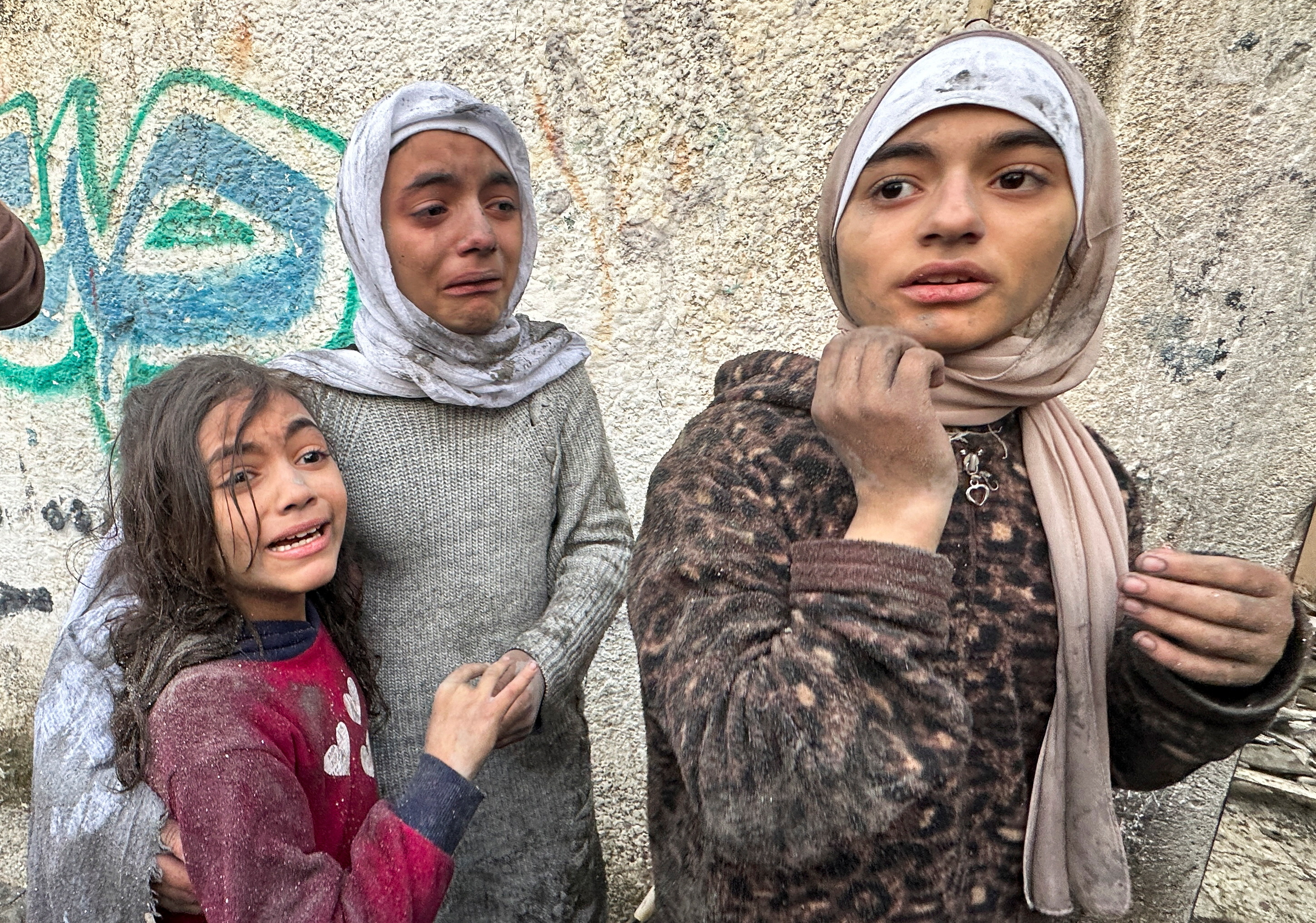 Children react following an Israeli air strike on Palestinian houses, amid the ongoing conflict between Israel and the Palestinian Islamist group Hamas, in Rafah in the southern Gaza Strip December 12