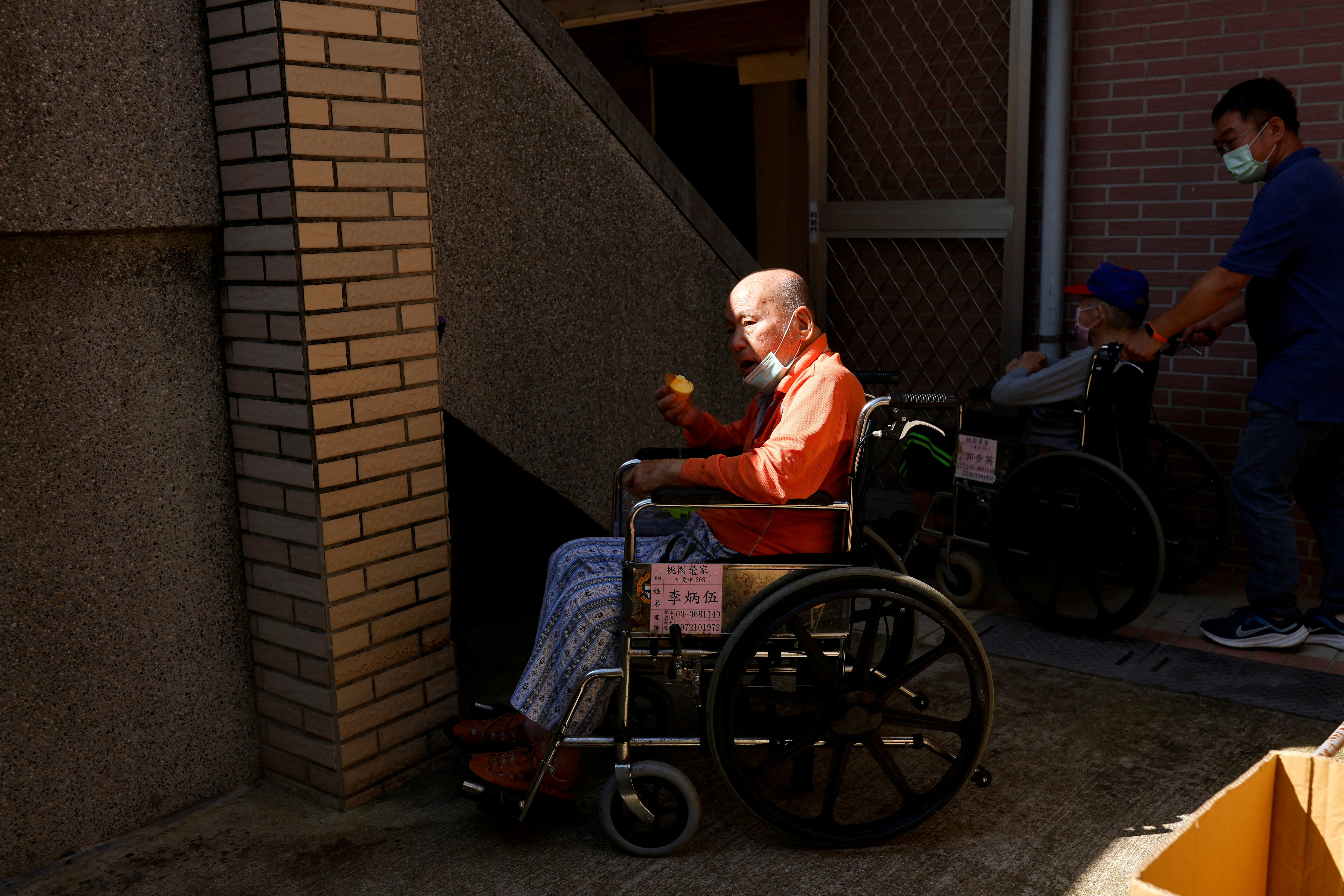 A resident at Taoyuan Veterans Home eats an apple in Taoyuan, Taiwan.