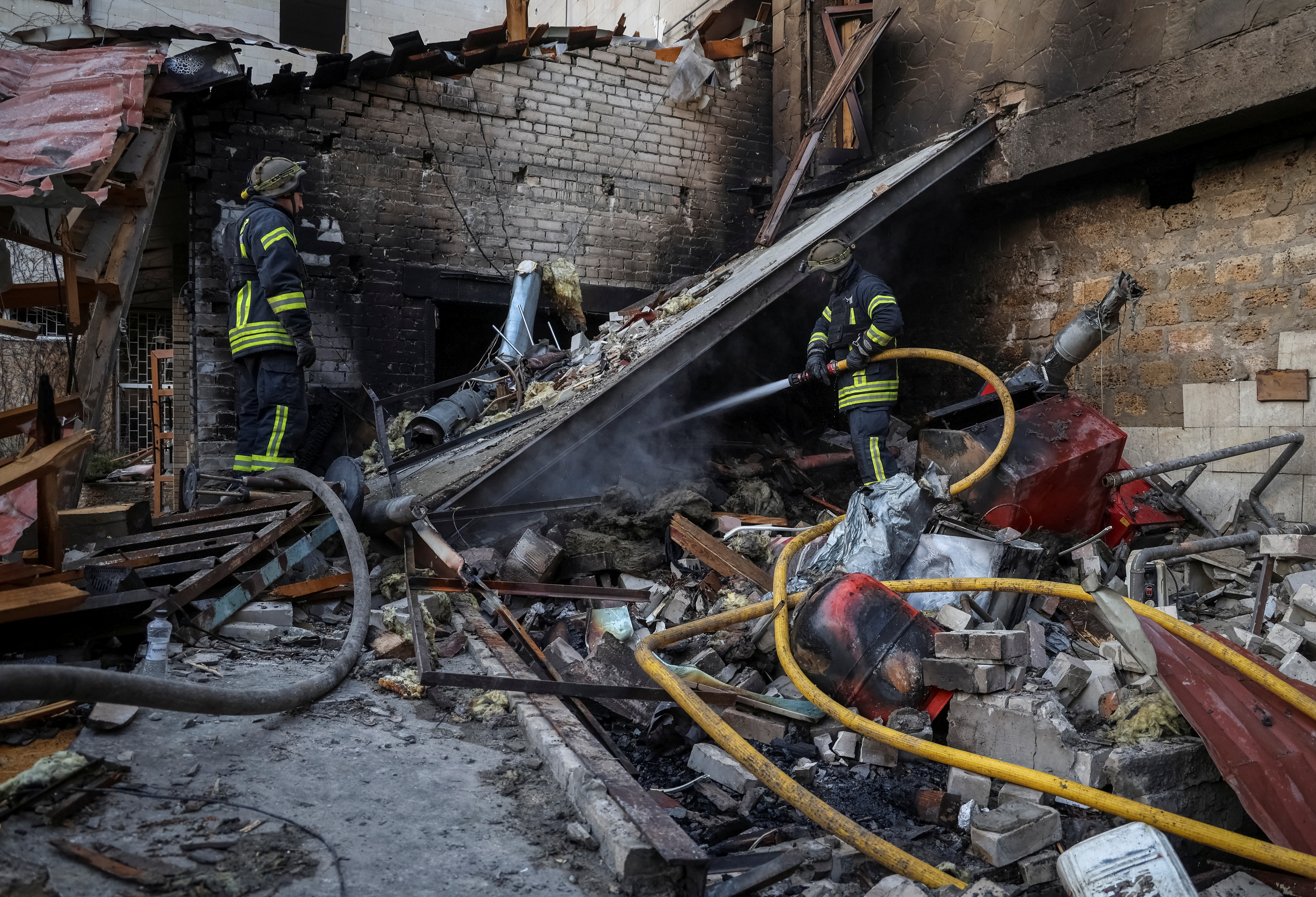 Rescuers work at a site of Russian military strike, in Kherson, Ukraine