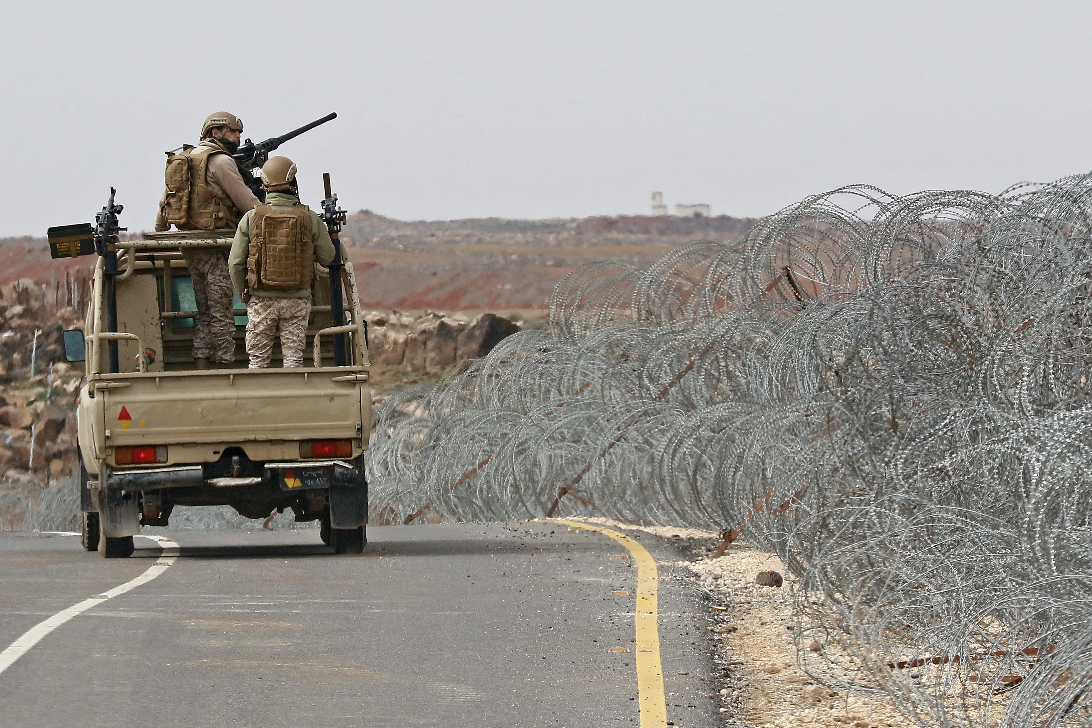 A picture taken during a tour origanized by the Jordanian Army shows soldiers patrolling along the border with Syria to prevent trafficking, on February 17, 2022. Drug trafficking from Syria into Jordan is becoming "organised" with smugglers stepping up operations and using sophisticated equipment including drones, Jordan's army said, warning of a shoot-to-kill policy. Since the beginning of this year, Jordan's army has killed 30 smugglers and foiled attempts to smuggle into the kingdom from Syria 16 million Captagon pills -- more than they seized in the whole of 2021 -- the military said. (Photo by Khalil MAZRAAWI / AFP)