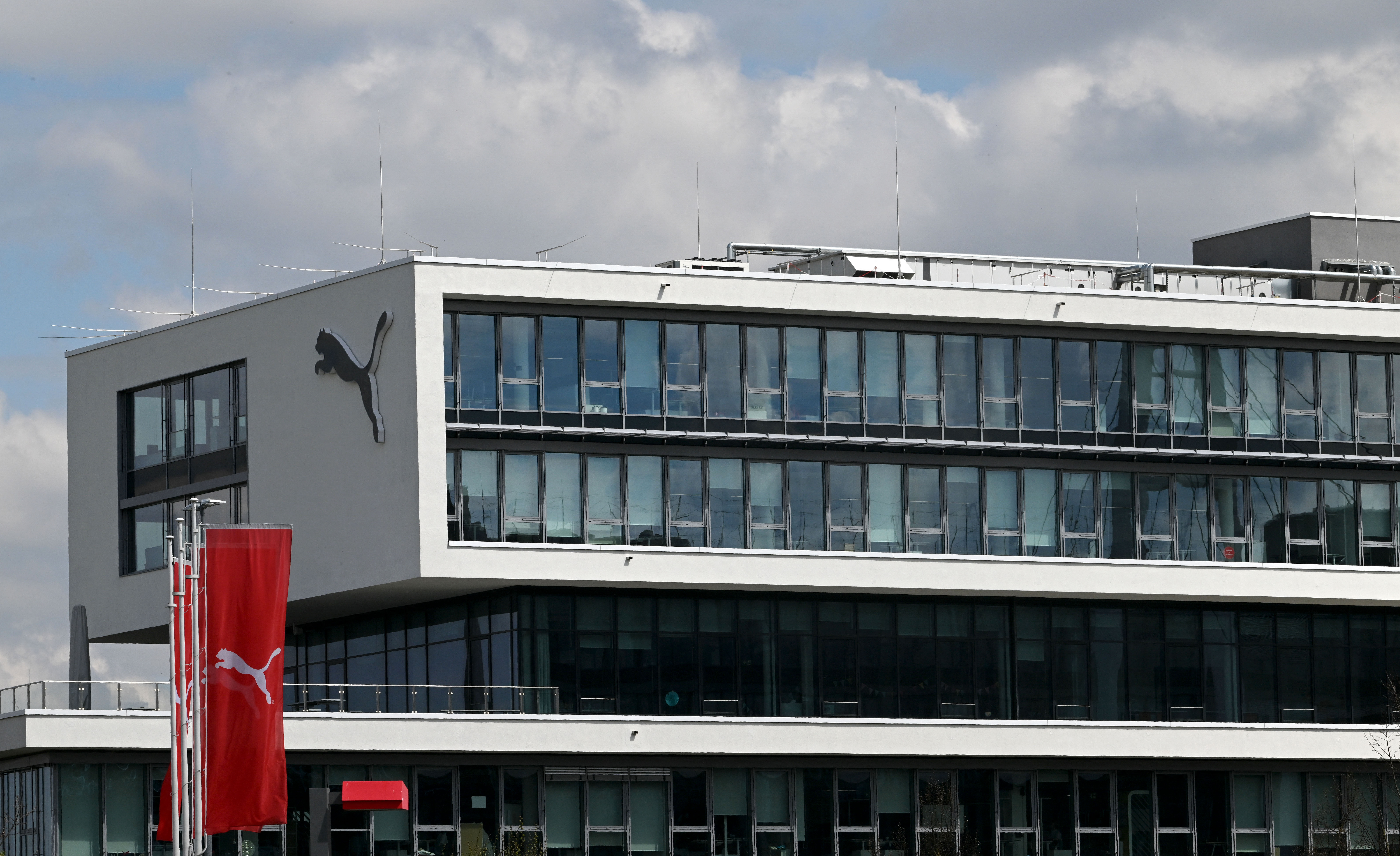 The logo of Germany's sportswear maker Puma is seen on the company headquarters in Herzogenaurach, southern Germany, on April 21, 2022. (Photo by Christof STACHE / AFP)