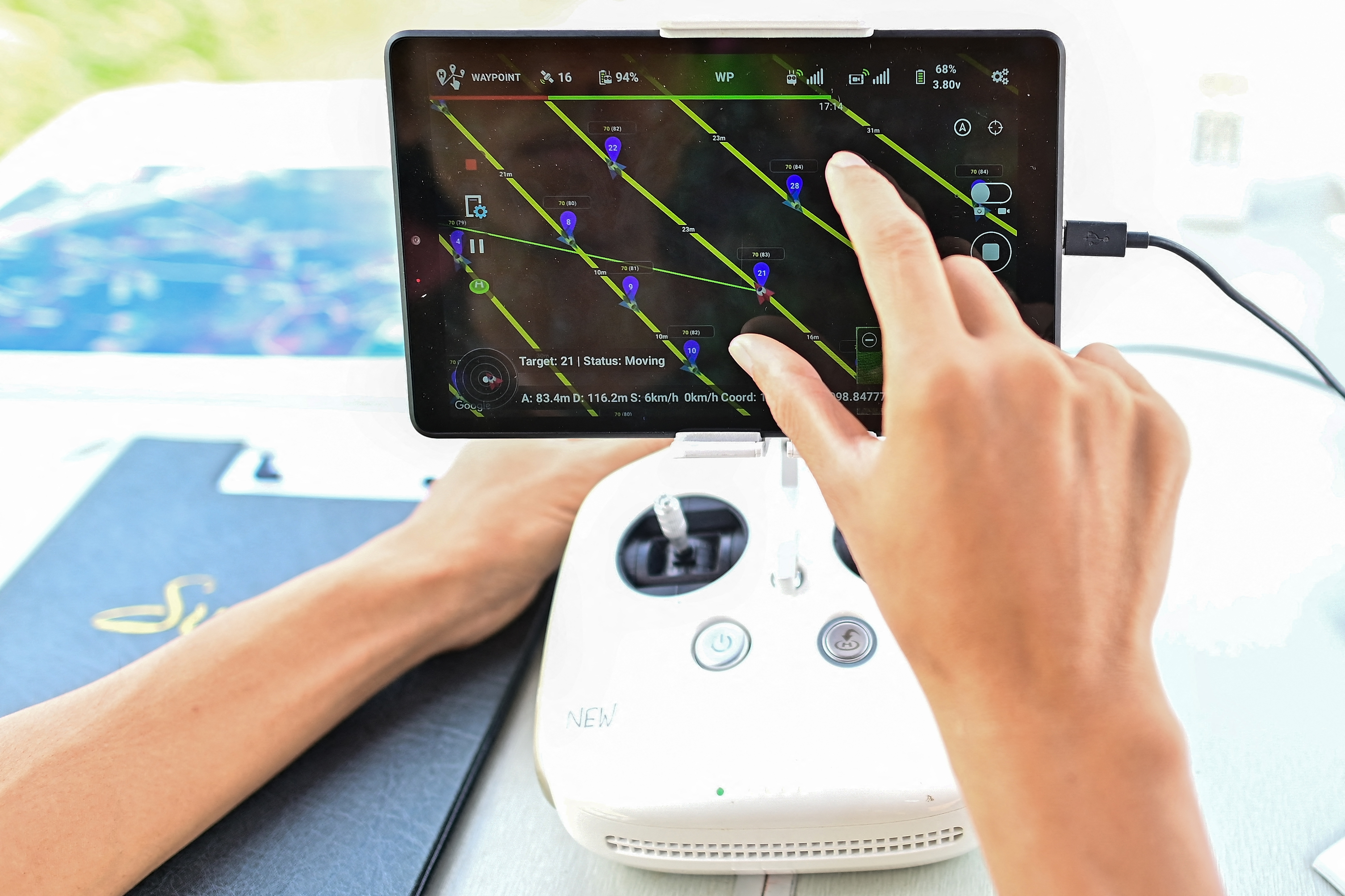 This picture taken on November 22, 2023 shows Chiang Mai University's Forest Restoration Research Unit (FORRU) field research officer Worayut Takaew showing on display the path of a drone to assist in forest mapping of a reforested land on a hillside near Chiang Mai.