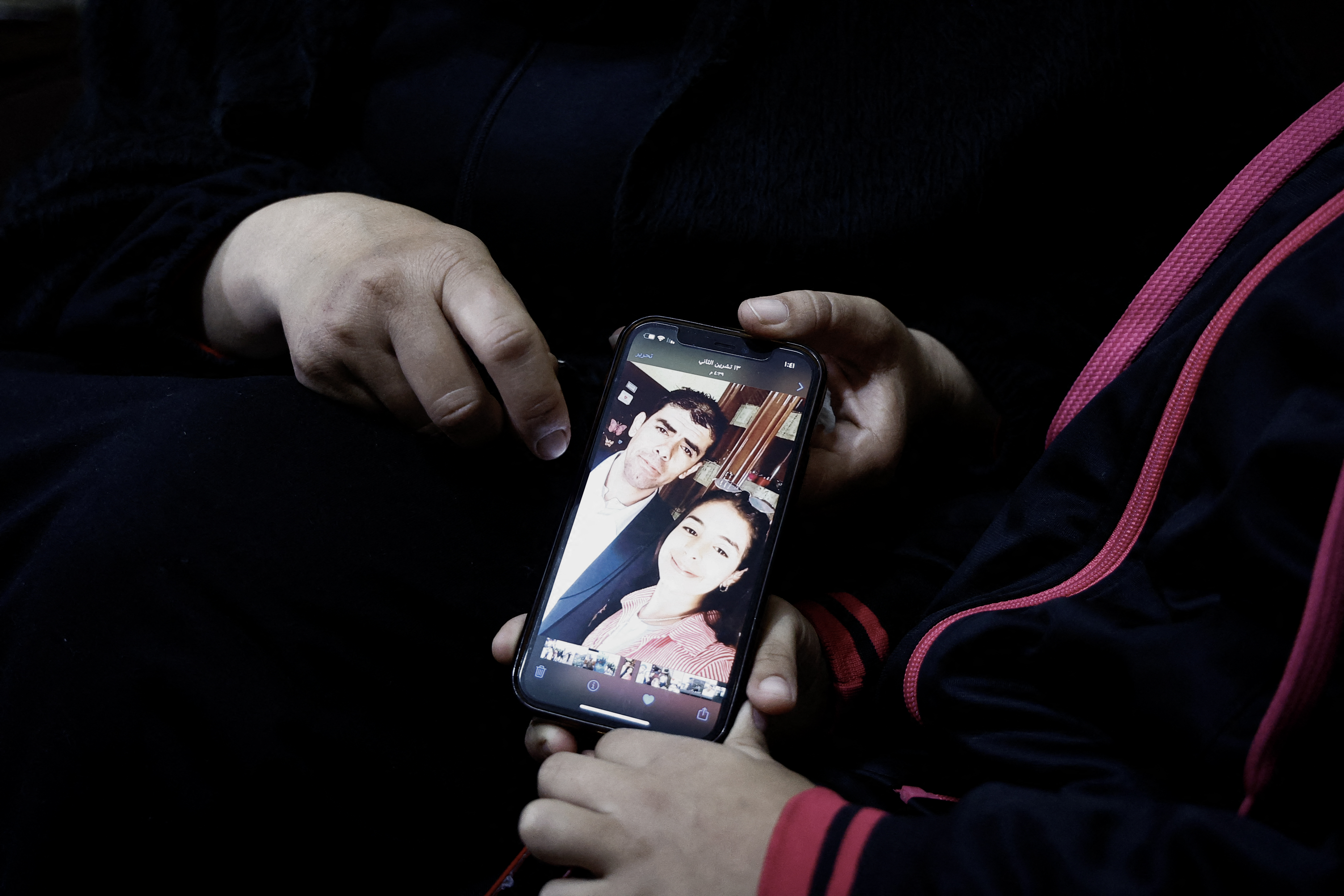 The wife of Bilal Saleh shows a picture her late husband at the village of As-Sawiyah, south of Nablus in the occupied West Bank.