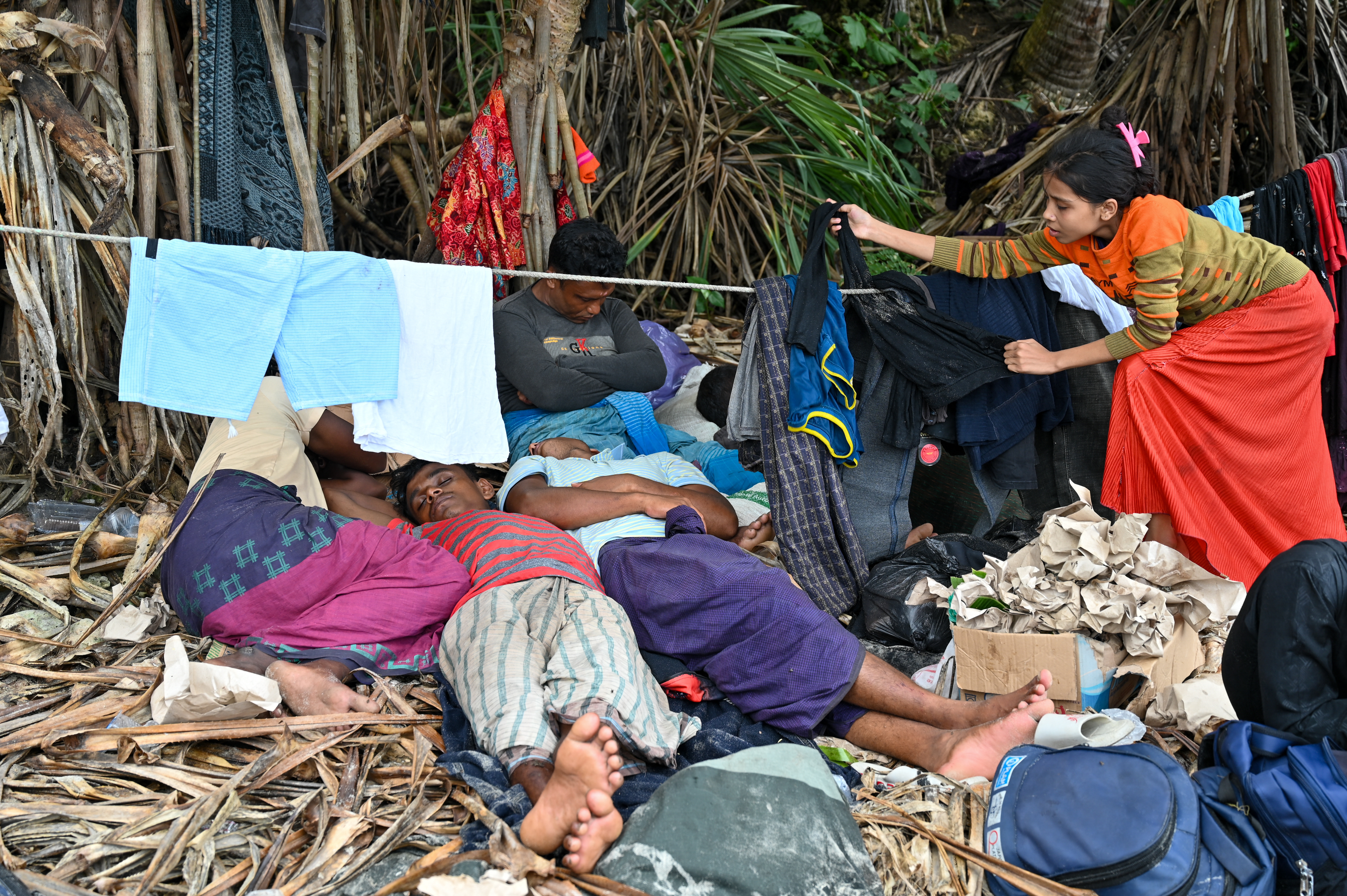 Newly-arrived Rohingya refugees rest at a beach on Sabang island, Aceh province, on December 2