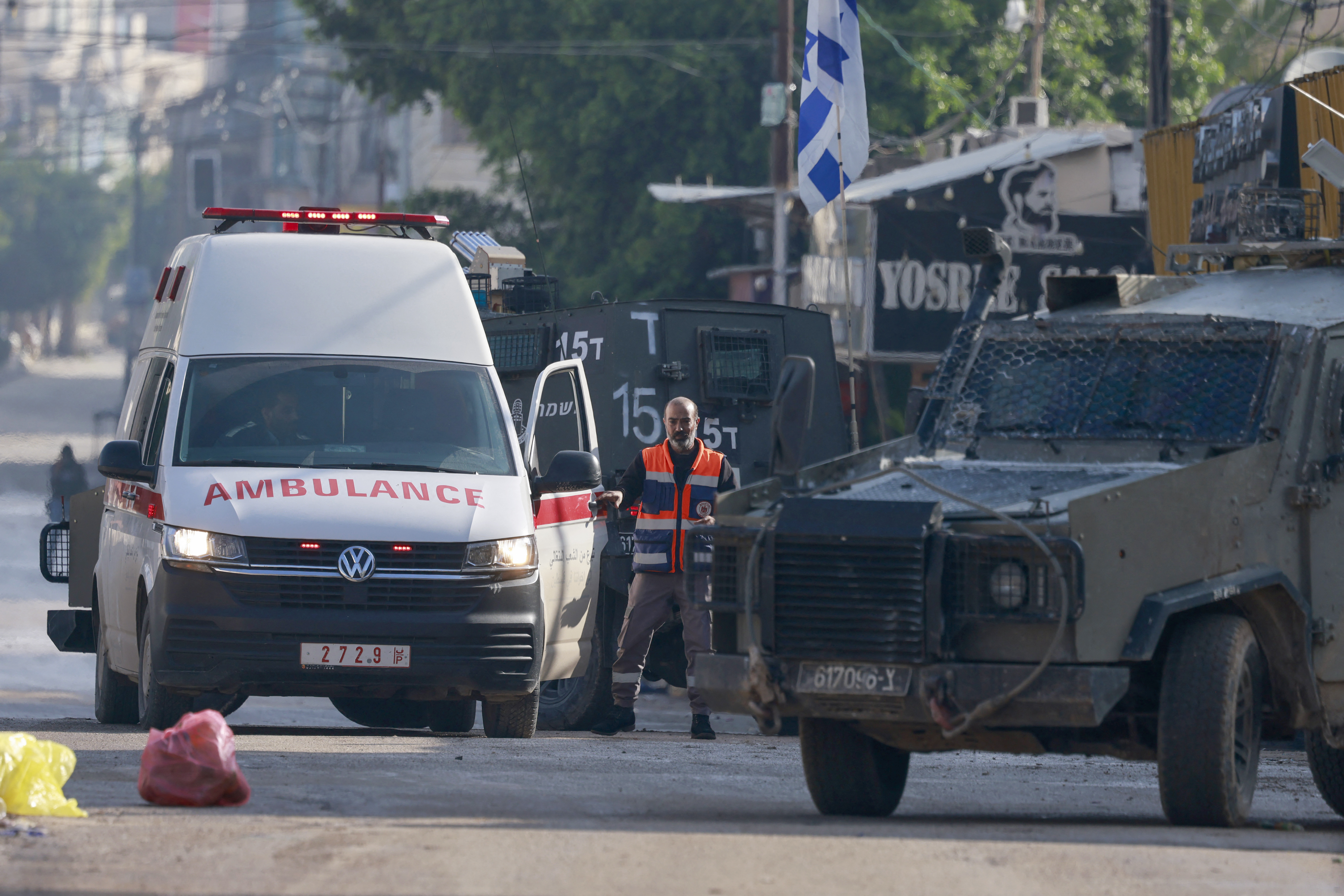 Israeli security forces search a Palestinian ambulance