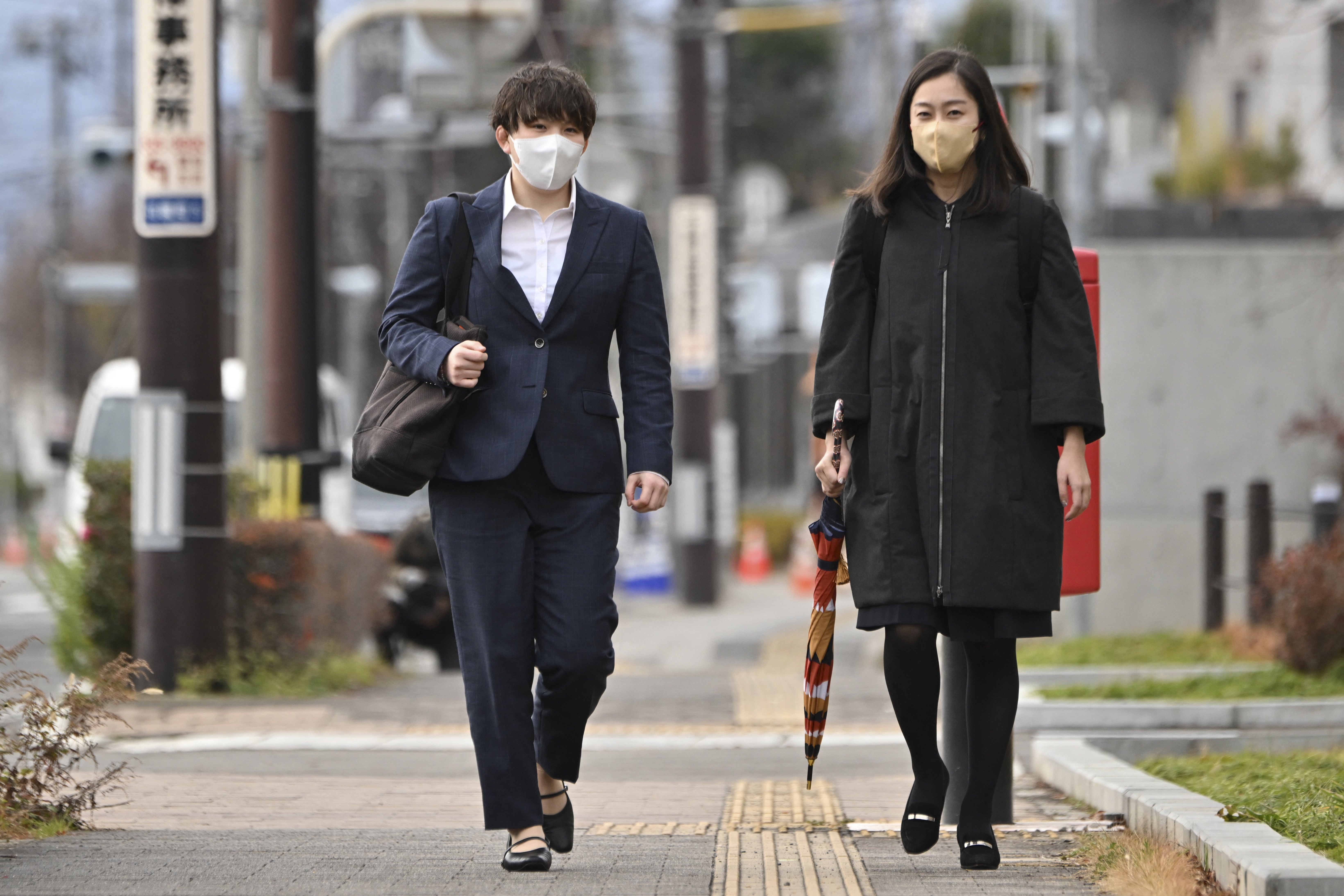 Former member of Japan's Ground Self-Defense Force Rina Gonoi (L) arrives on December 12, 2023 at the Fukushima District Court, which found three ex-soldiers guilty of sexually assaulting her. - The Fukushima court found Shutaro Shibuya, Akito Sekine and Yusuke Kimezawa guilty of "forced indecency" towards Rina Gonoi during a military drill in 2021 and handed down jail terms of two years, suspended for four years. (Photo by Kazuhiro NOGI / AFP)