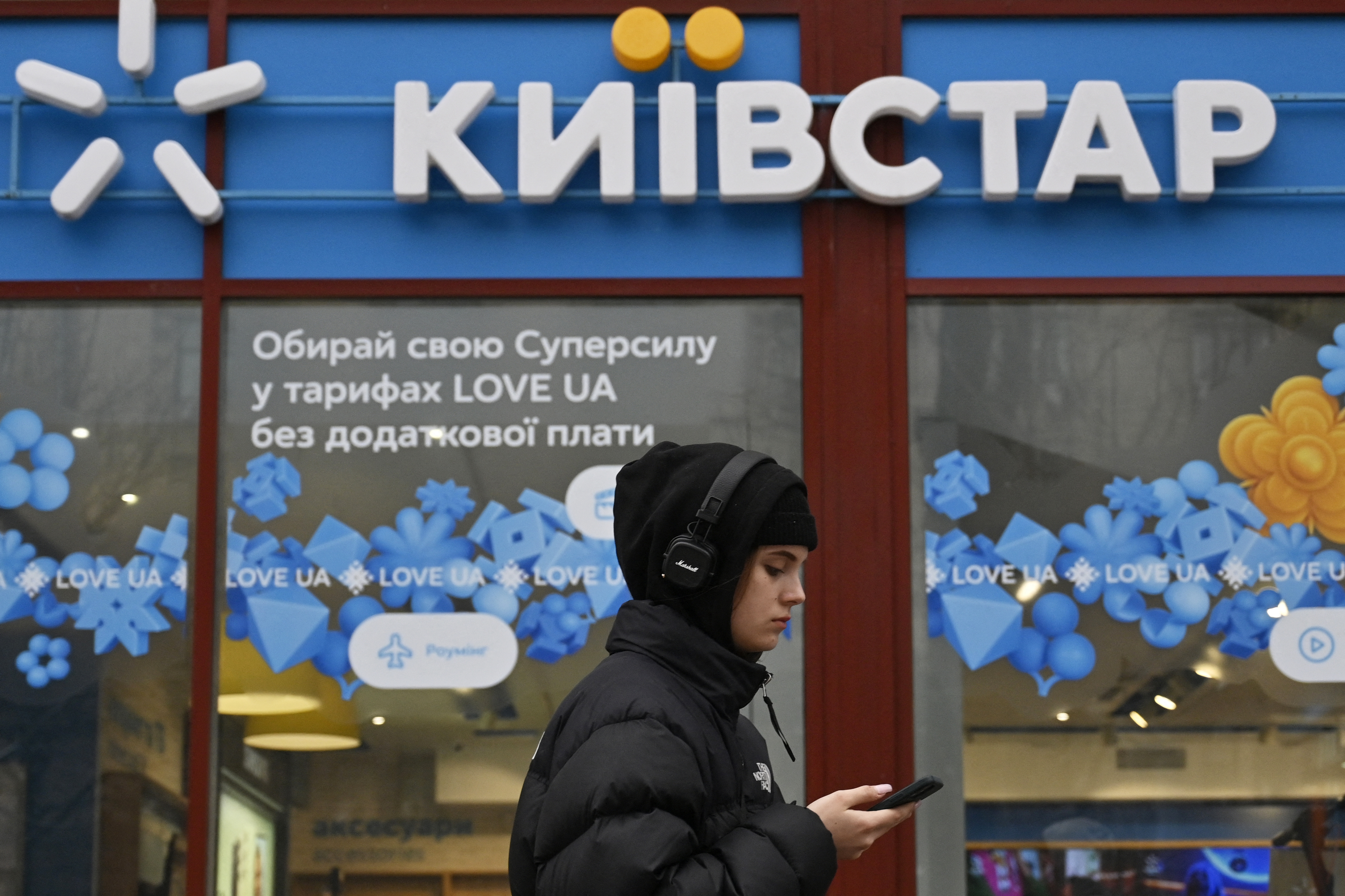A Kyivstar shop with a woman walking past