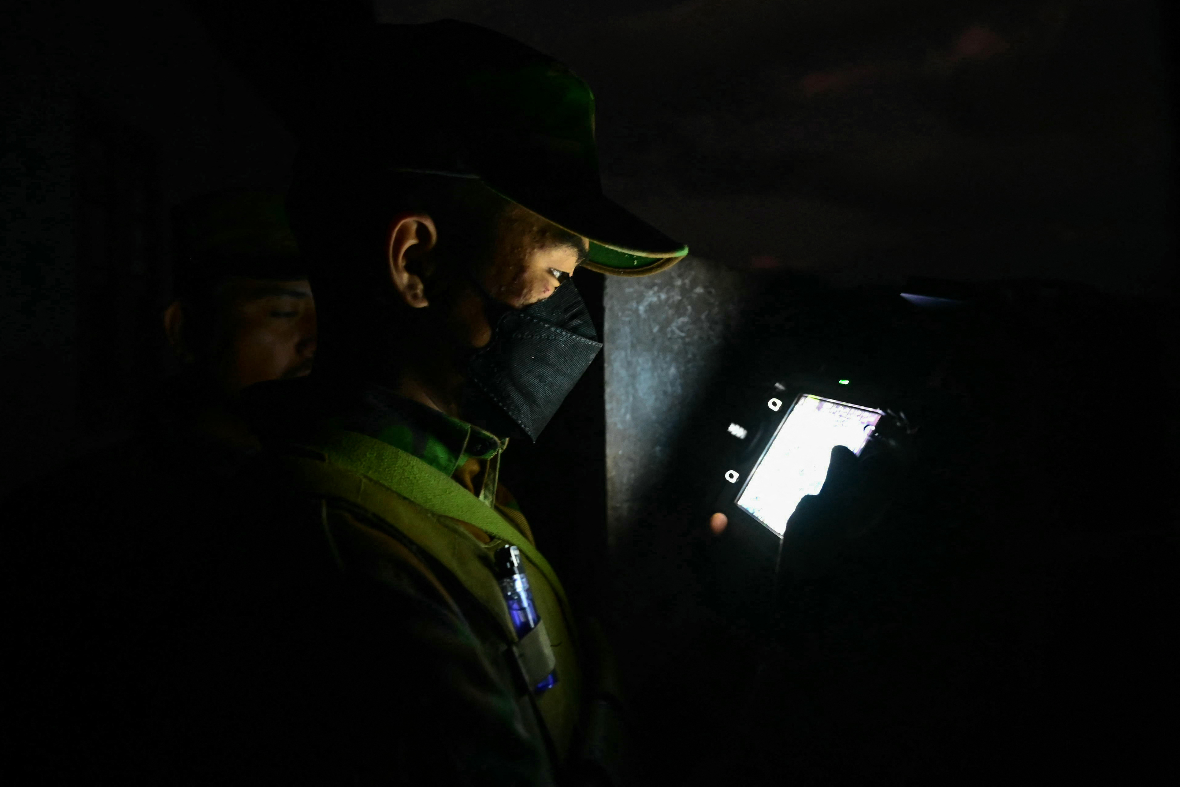 This photo taken on December 12, 2023 shows a member of ethnic minority armed group Ta'ang National Liberation Army (TNLA) controlling a drone during their attack on Myanmars military camp in Namhsan Township in Myanmar's northern Shan State.