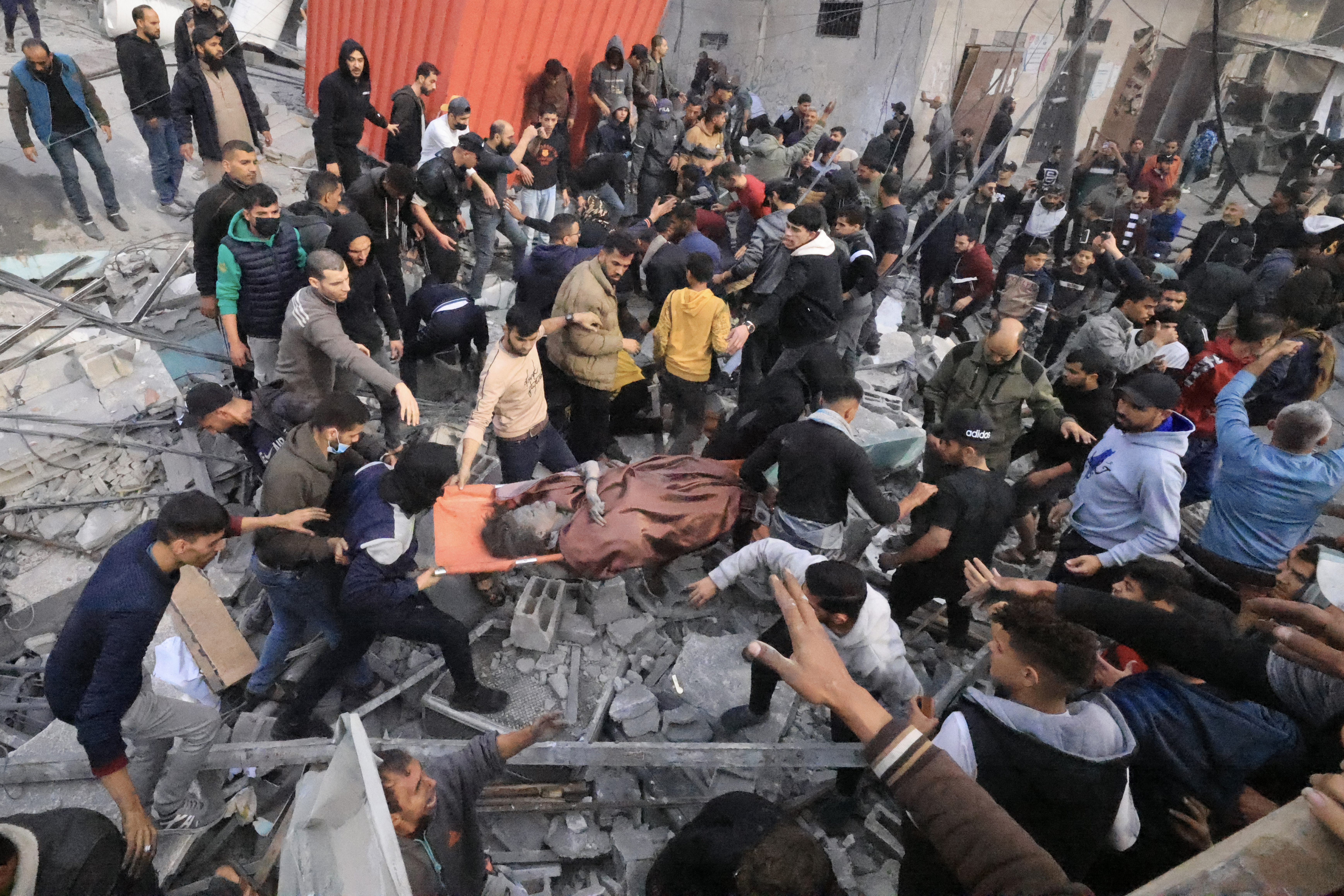 People evacuate a wounded girl following an Israeli strike on the Ali ben Abi Taleb Mosque in Rafah in the southern Gaza Strip.