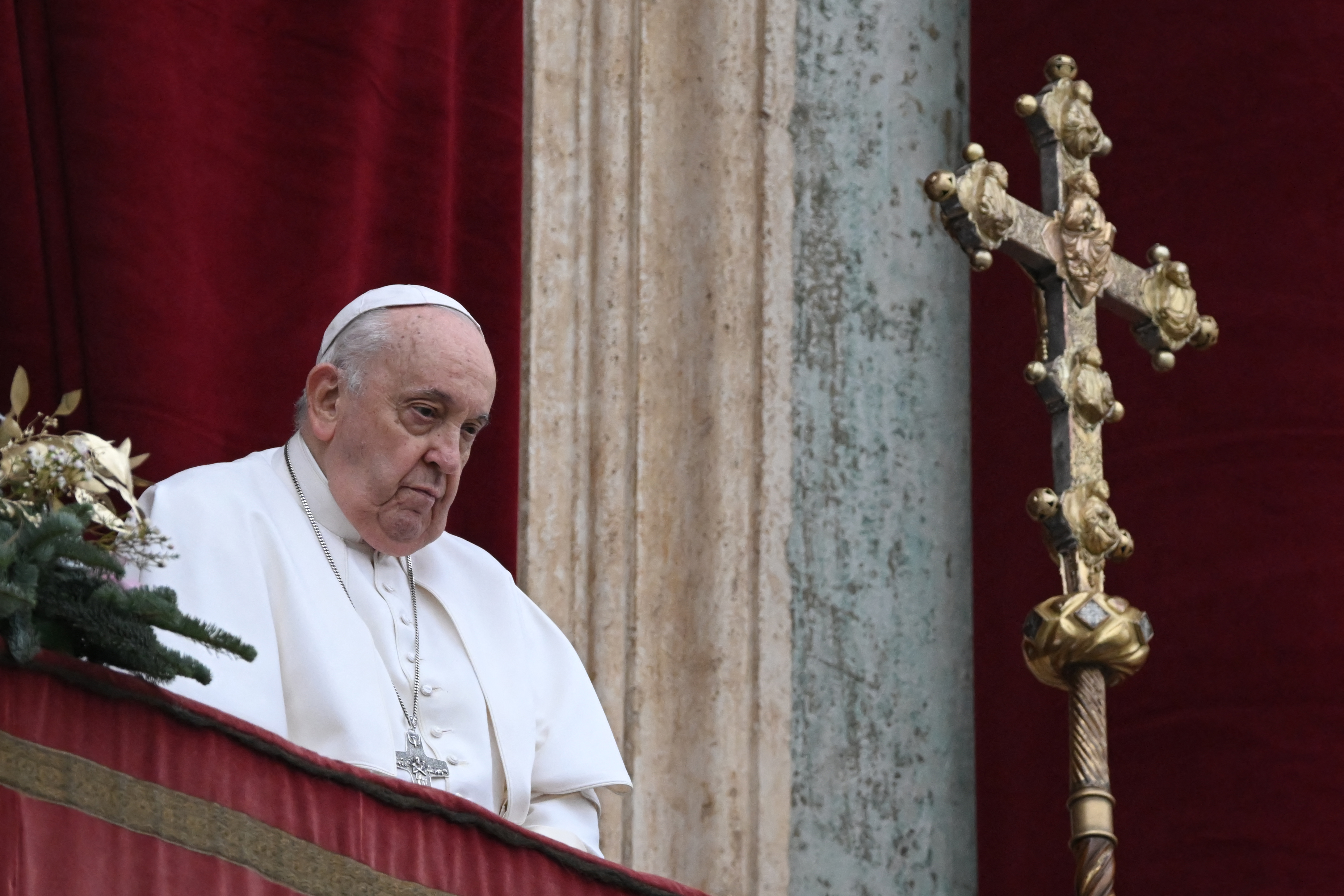 Pope Francis stands at the balcony of St. Peter's basilica to deliver the Christmas Urbi et Orbi blessing in St. Peter's Square at The Vatican on December 25, 2023. (Photo by Tiziana FABI / AFP)