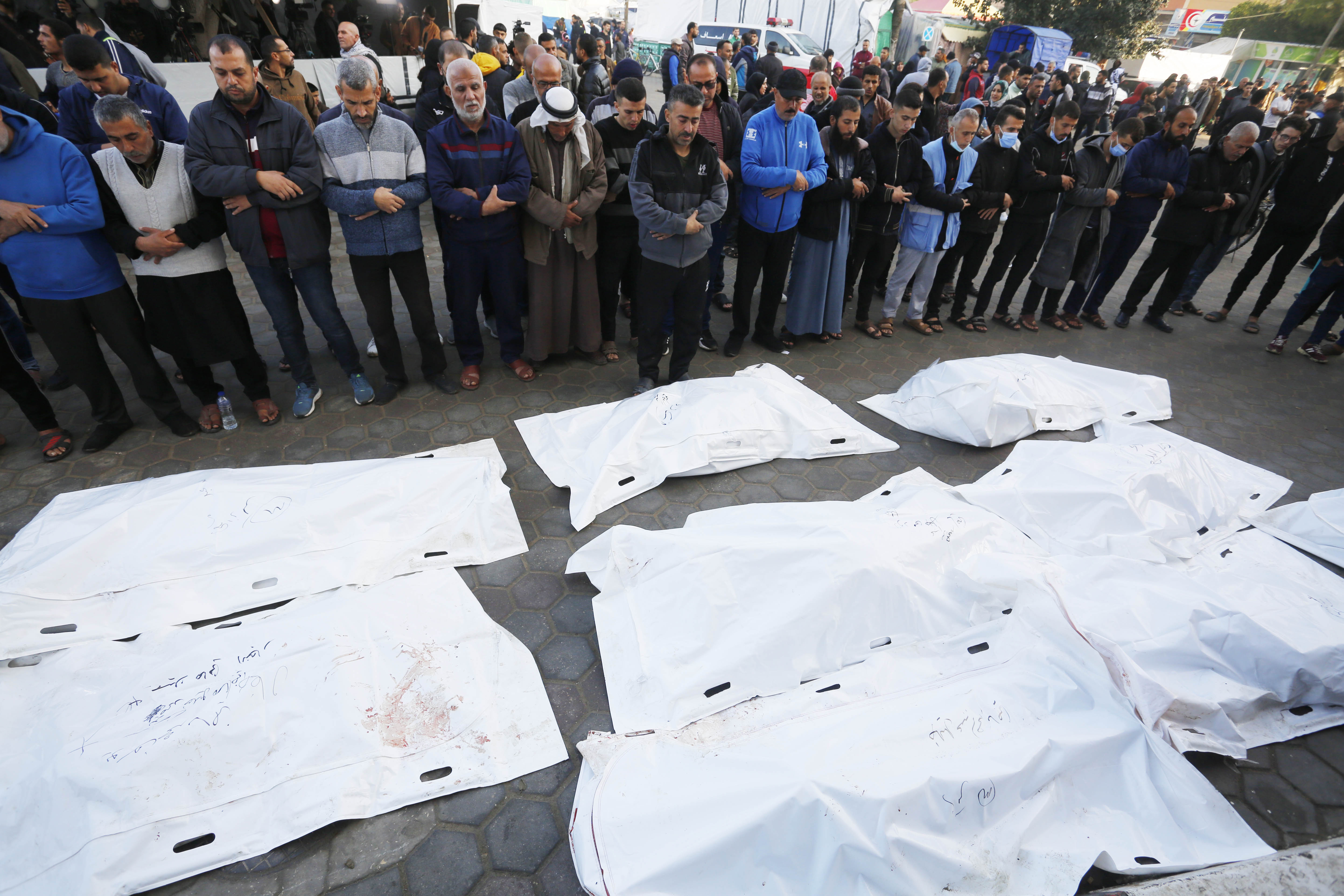 People perform funeral prayer for the Palestinians that lost their lives during the Israeli attacks in Deir Al-Balah, Gaza.