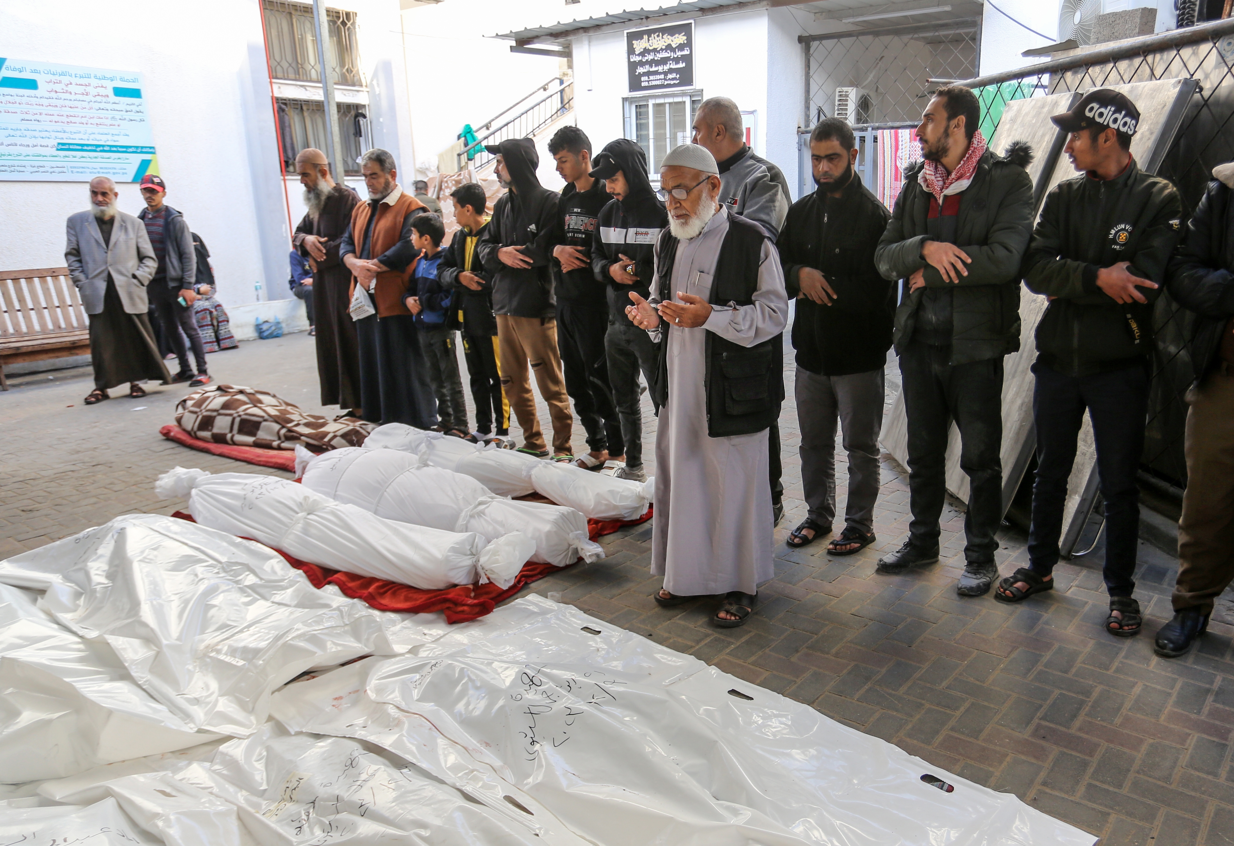 People attend the funeral ceremony for the Palestinians died in Israeli attacks, as the bodies are taken by their relatives from the morgue of An-Najjar Hospital to be buried in Rafah, Gaza.