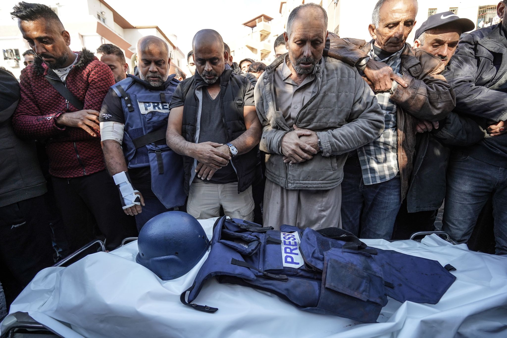 Mourners including Al Jazeera correspondent Wail al-Dahduh (2nd L) attend the funeral ceremony of Al Jazeera cameraman Samir Abu Dhaka, who died in the Israeli attacks in Khan Yunis, Gaza on December 16