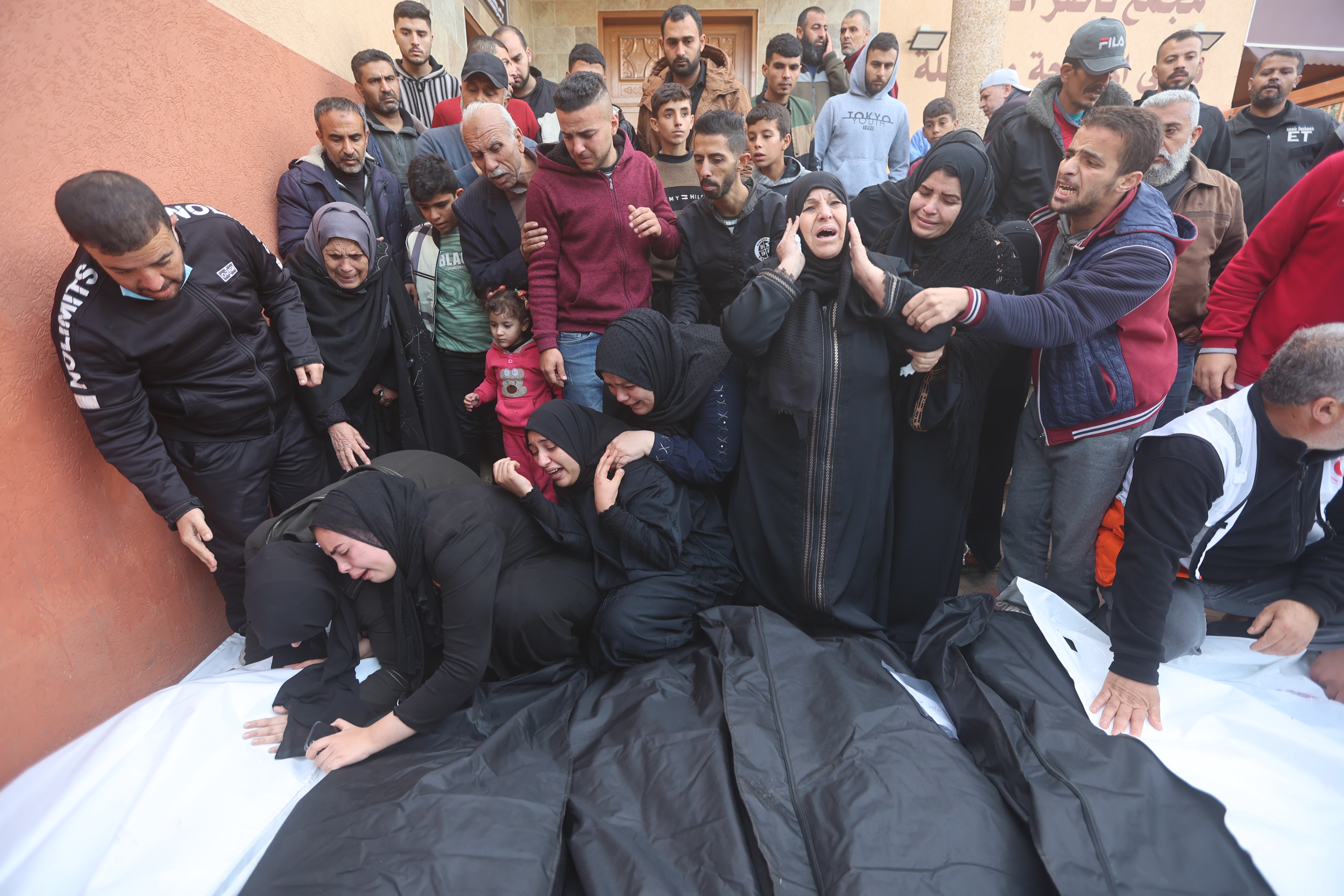 Relatives of the Palestinians died in Israeli attacks, mourn as they receive the dead bodies from the morgue of Nasser Hospital for burial in Khan Yunis, Gaza.