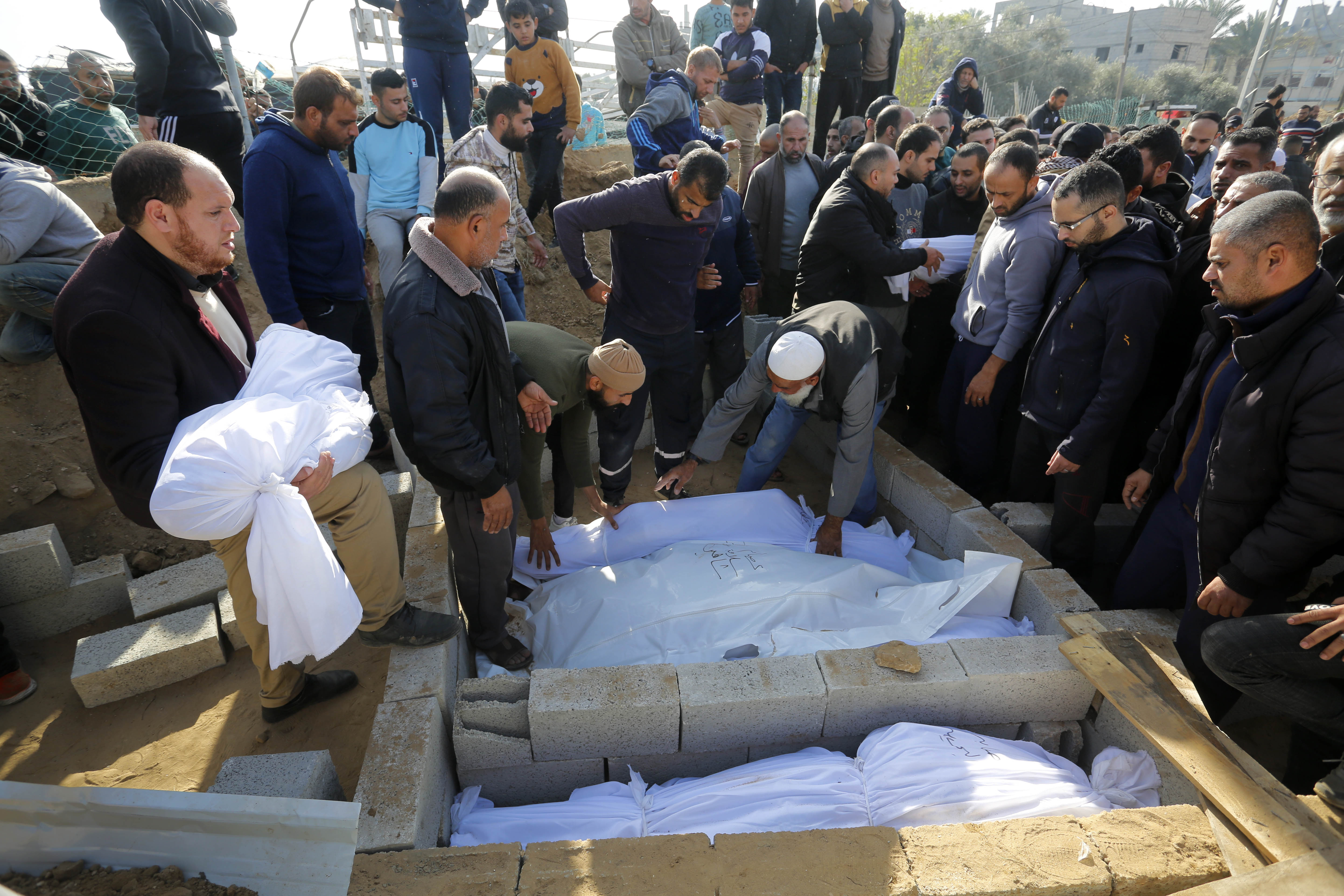 Palestinians who lost their lives in Israeli attacks are being buried in Deir al Balah Cemetery with prayers in Deir al Balah, Gaza.