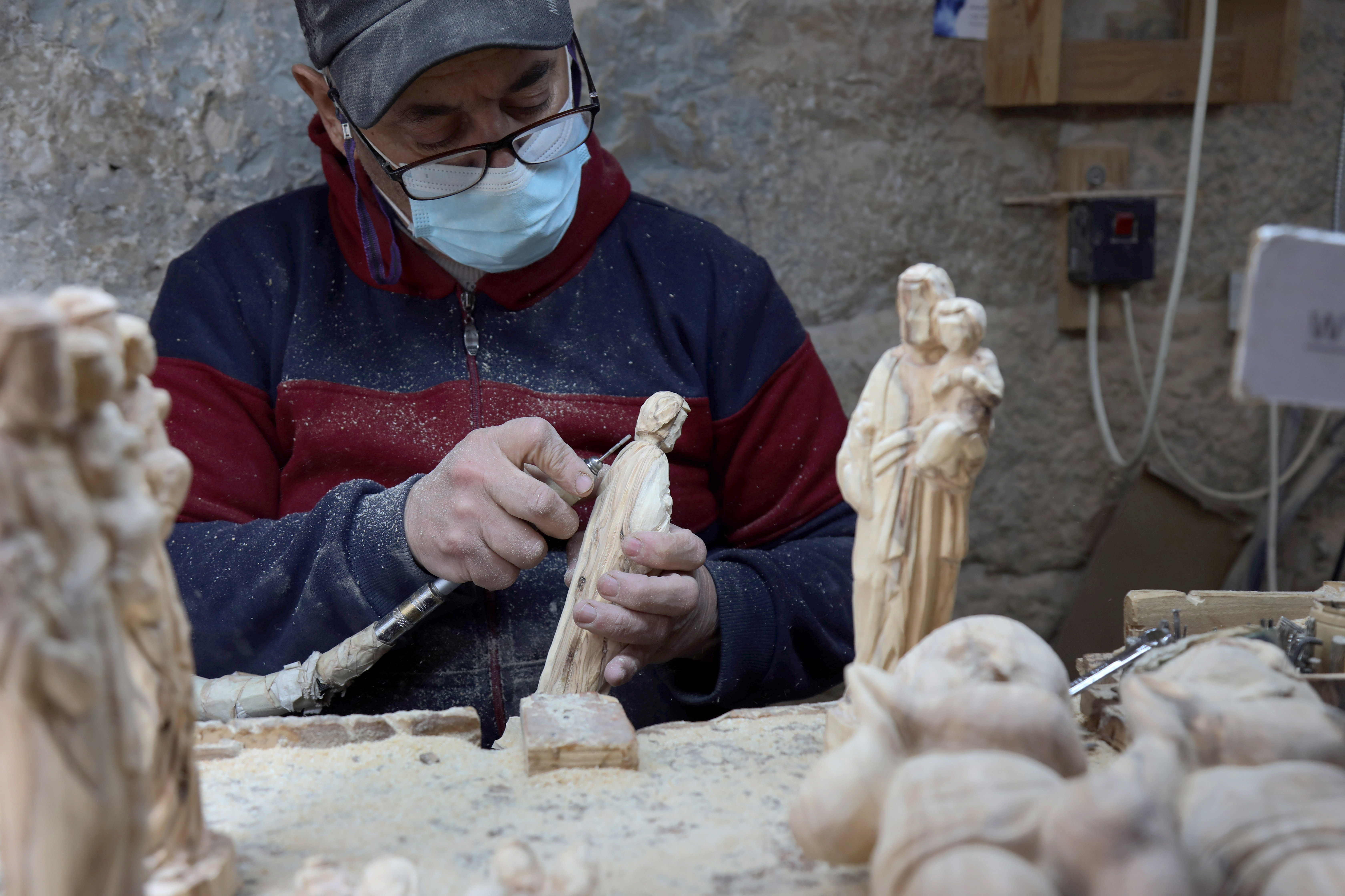 A view of a Palestinian carpenter who continues to work as the Israeli attack on Gaza has negatively affected the tourism season in Bethlehem, West Bank on December 23,