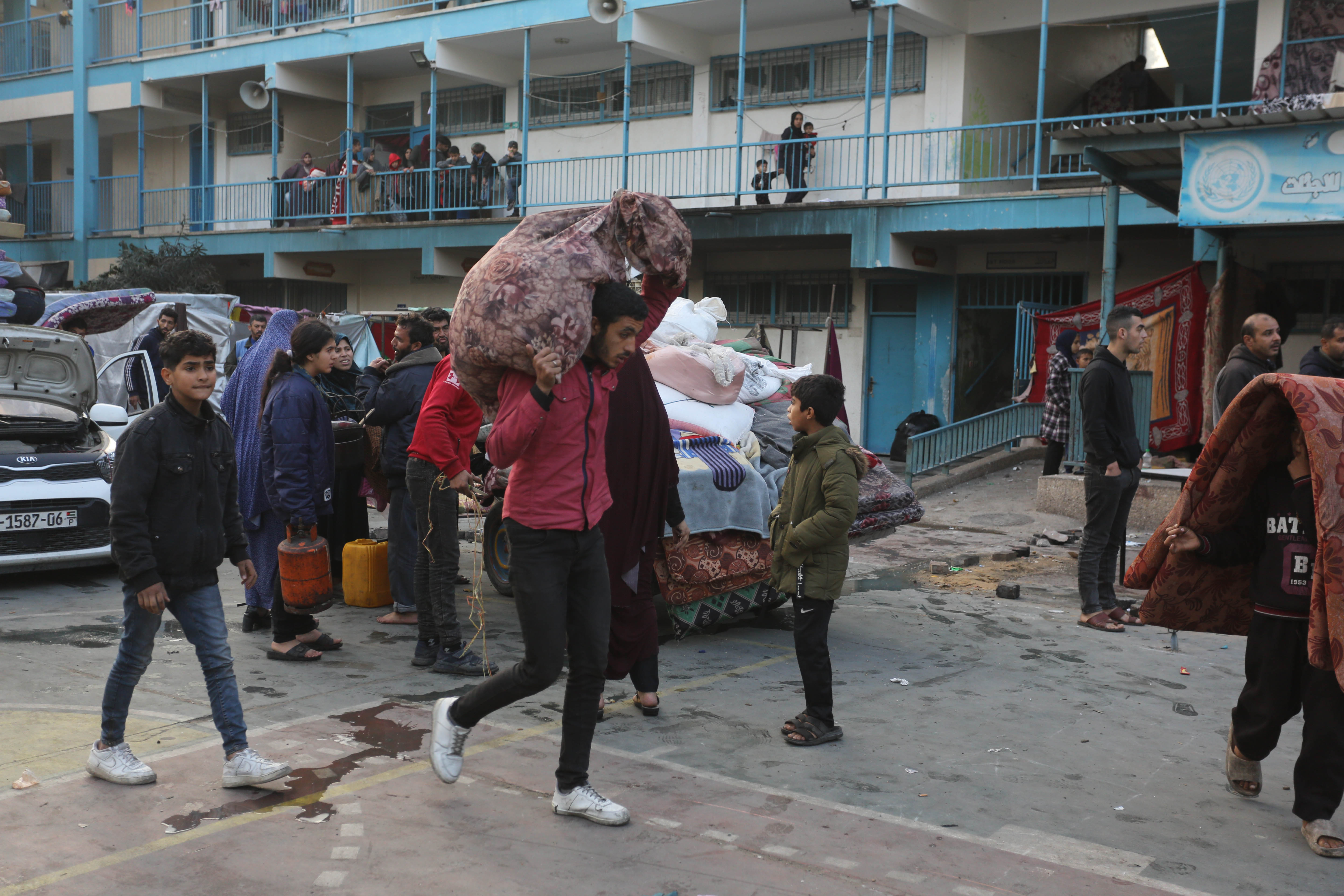 Palestinians gather their belongings and leave the area after Israeli airstrike hit Al-Maghazi School affiliated with UNRWA at Al-Maghazi refugee camp in Gaza Strip.