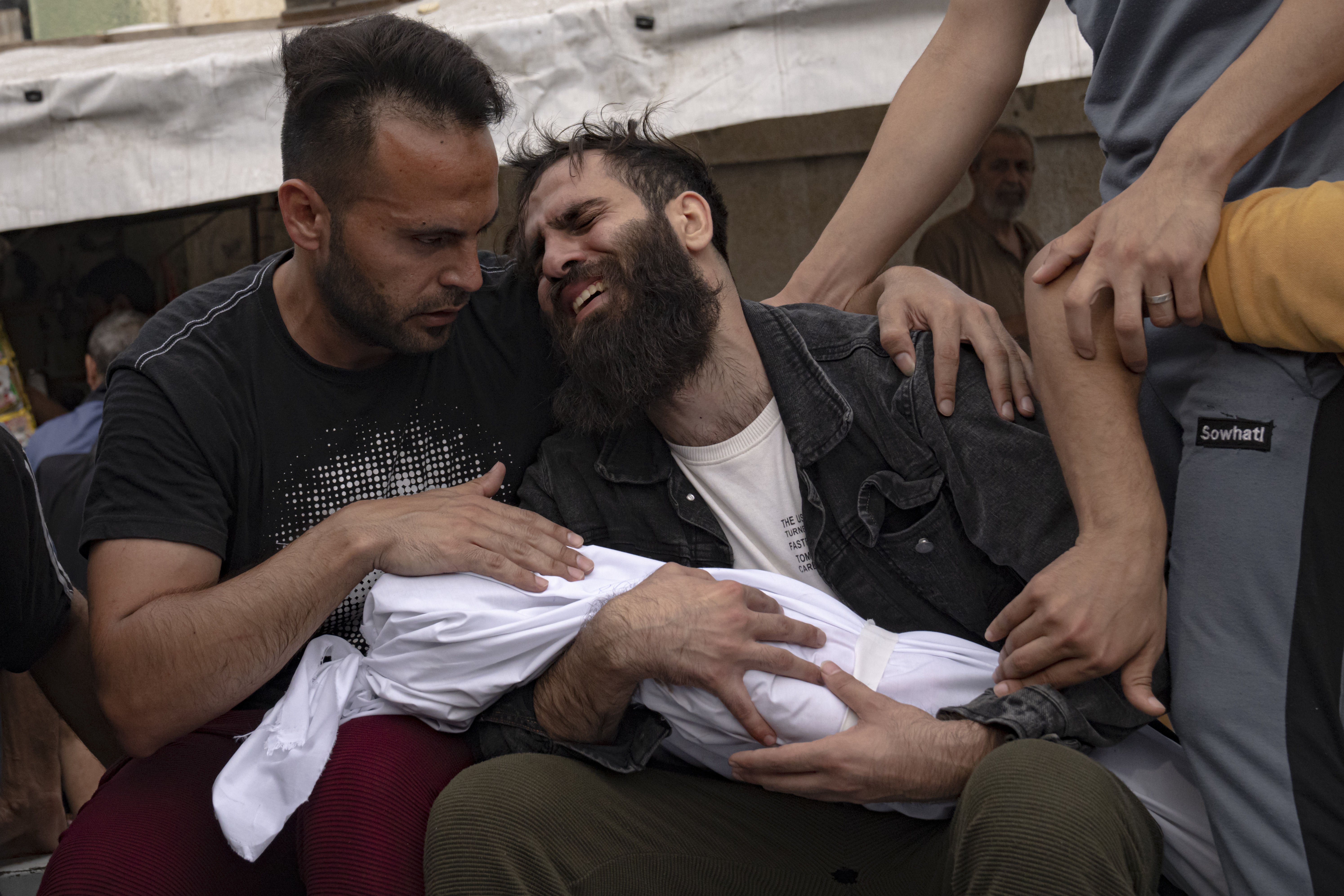 Palestinians mourn their relatives killed in the Israeli bombardment