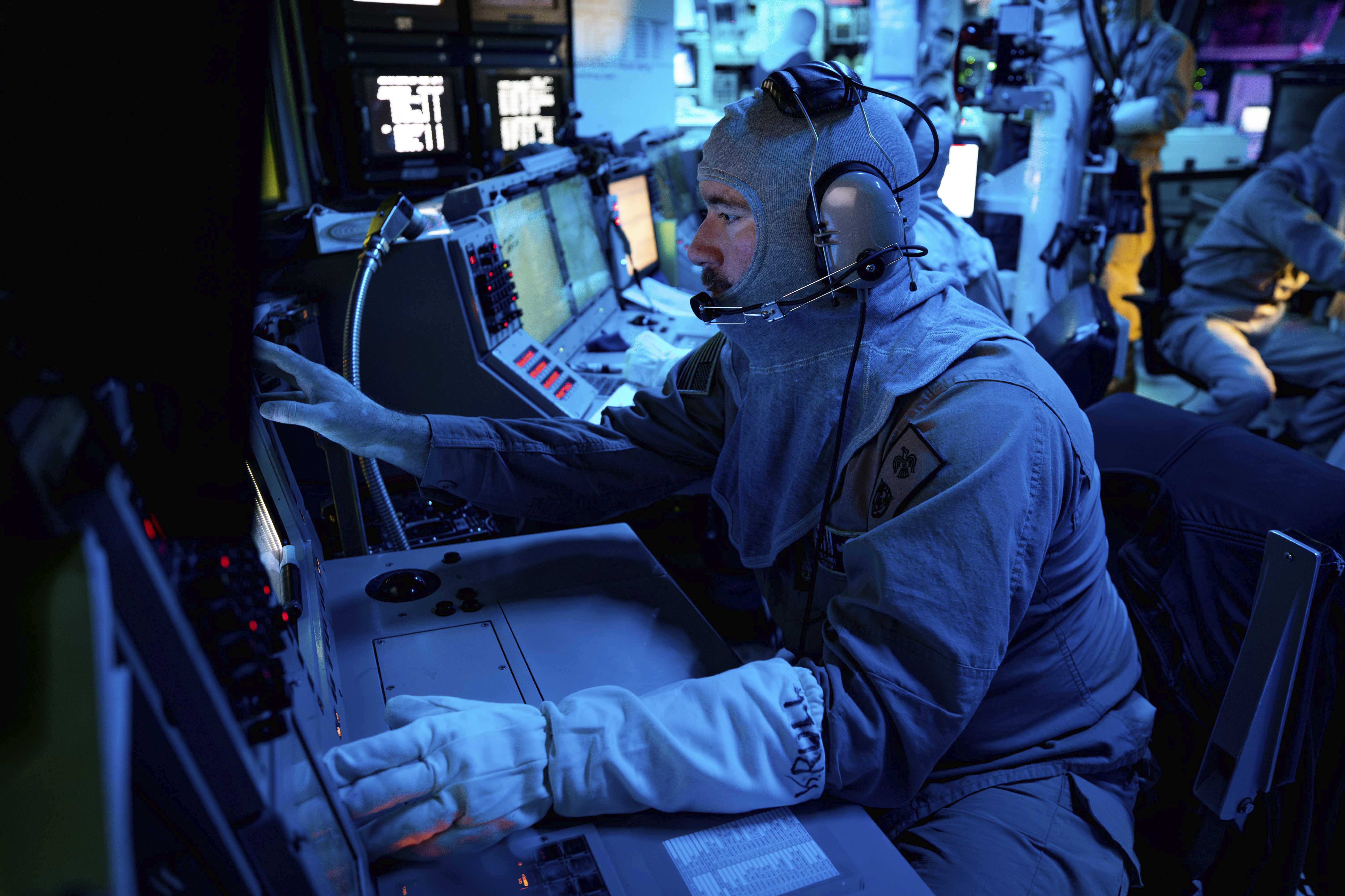 In this image provided by the U.S. Navy, Chief Fire Controlman (Aegis) Kenneth Krull, assigned to the USS Carney (DDG 64), mans the combat systems coordinator console in the combat information center during a general quarters drill on Oct. 14, 2023, in the Eastern Mediterranean. The warship sailing near the Bab el-Mandeb Strait shot down a drone launched from Yemen on Wednesday, Nov. 29, the U.S. military said, in the latest in a string of threats from Iranian-backed Houthi rebels