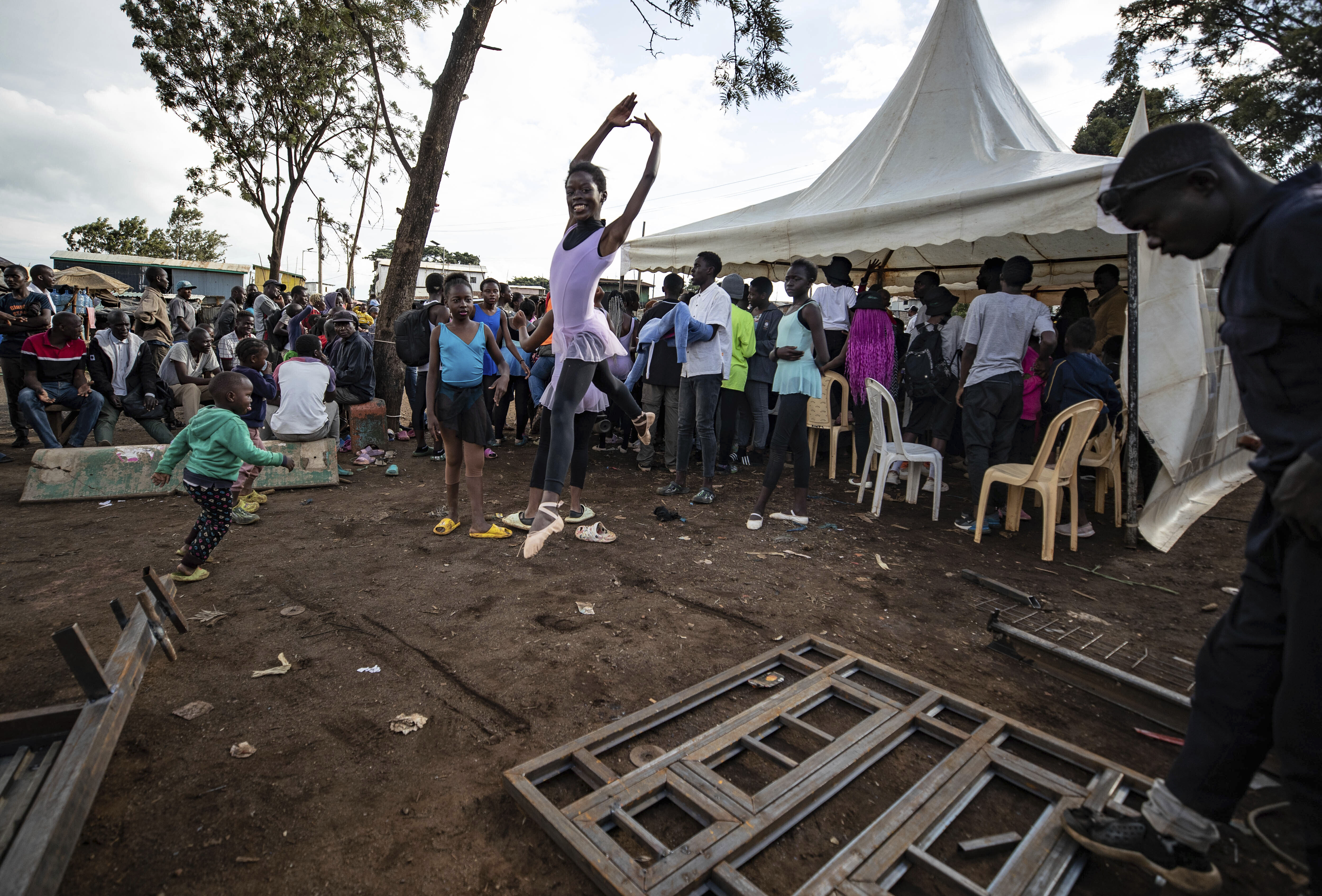 Young dancers practice by the Kenya - Uganda railway line
