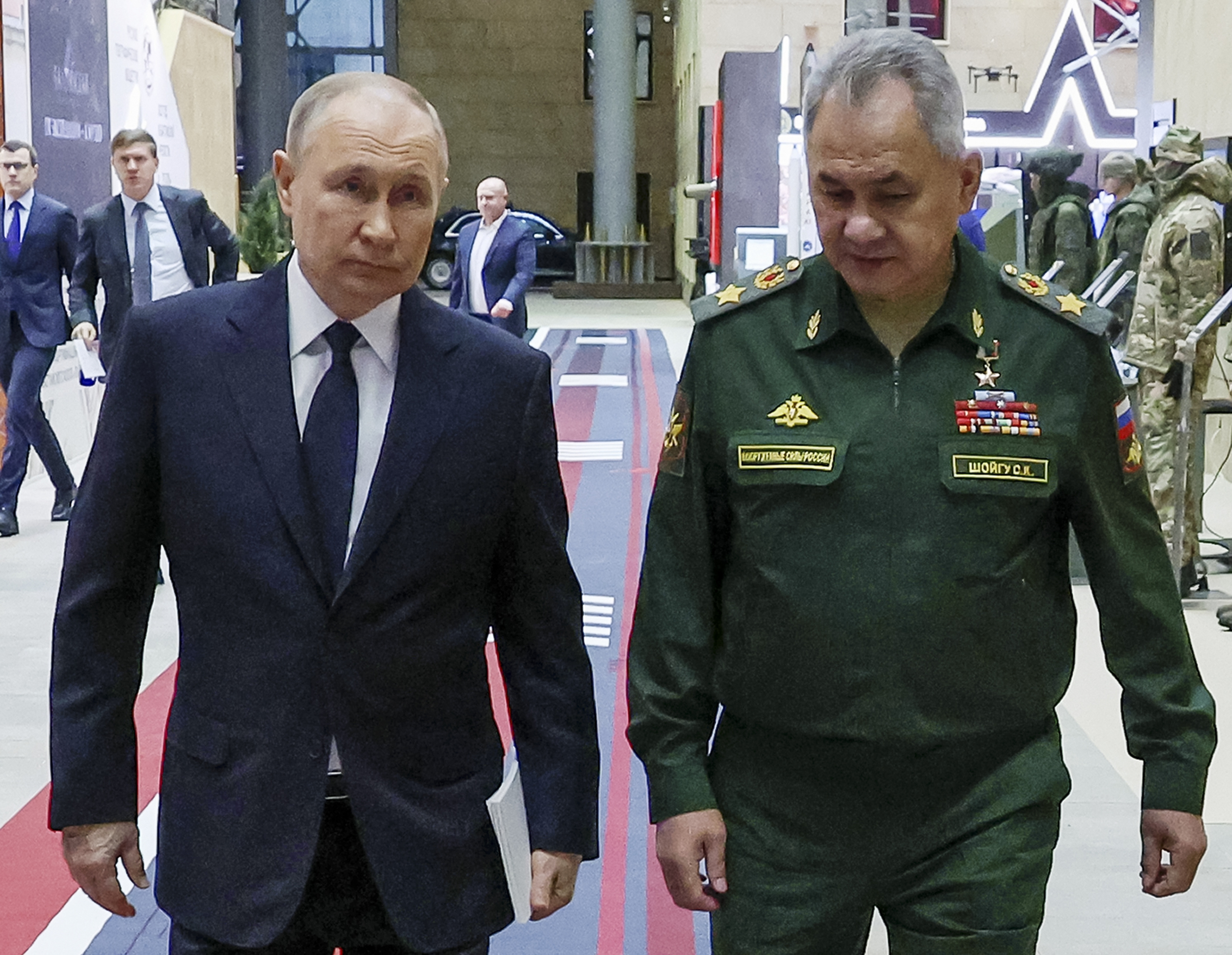 Russian President Vladimir Putin (left) and Russian Defence Minister Sergei Shoigu walking together