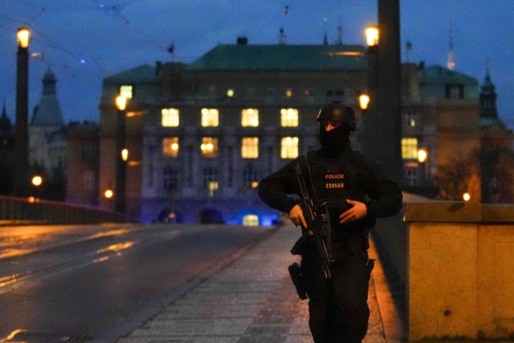 A police officer stands on a bridge near the site of a mass shooting