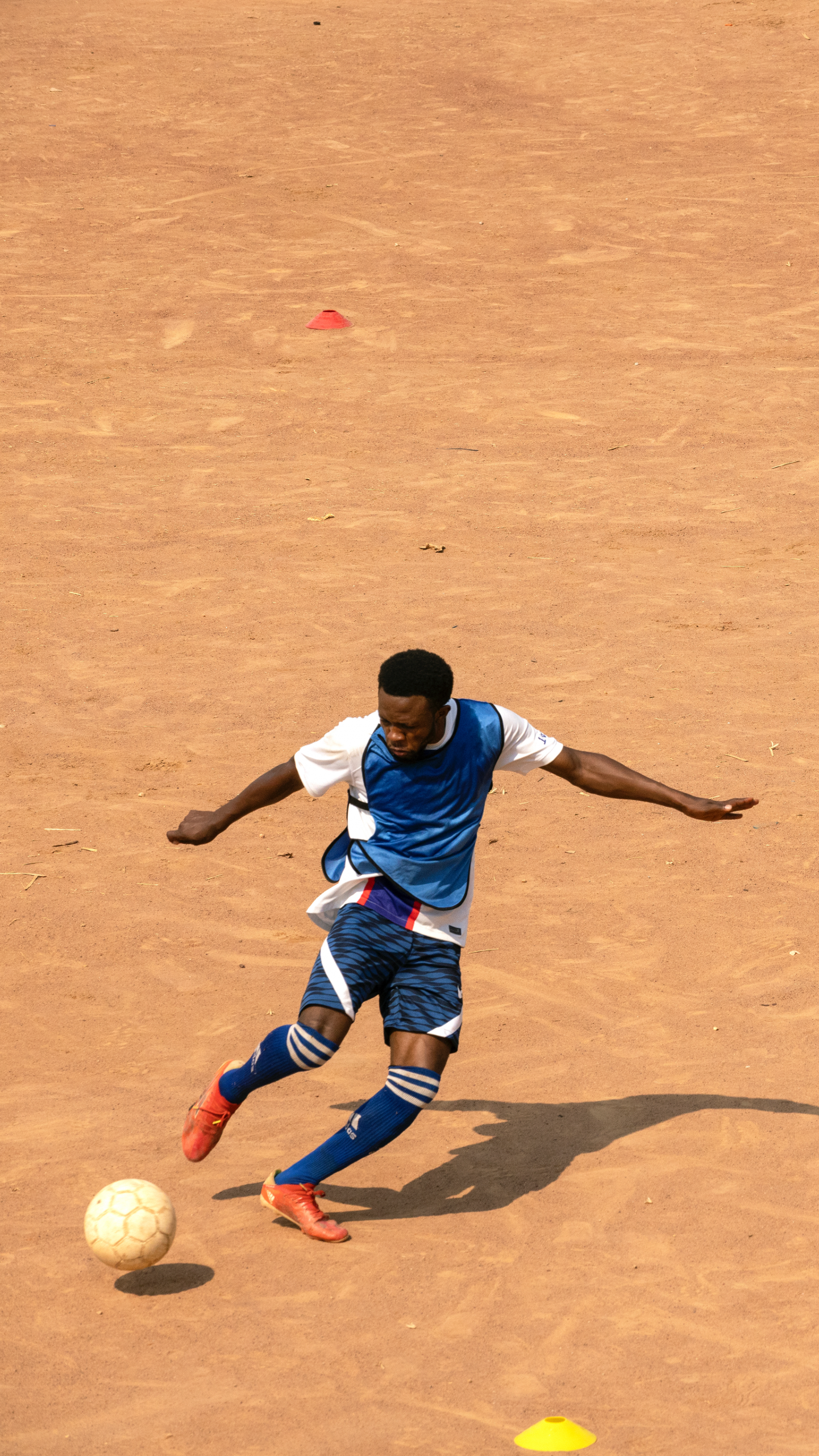 Football players on a field in a refugee camp in Zambia