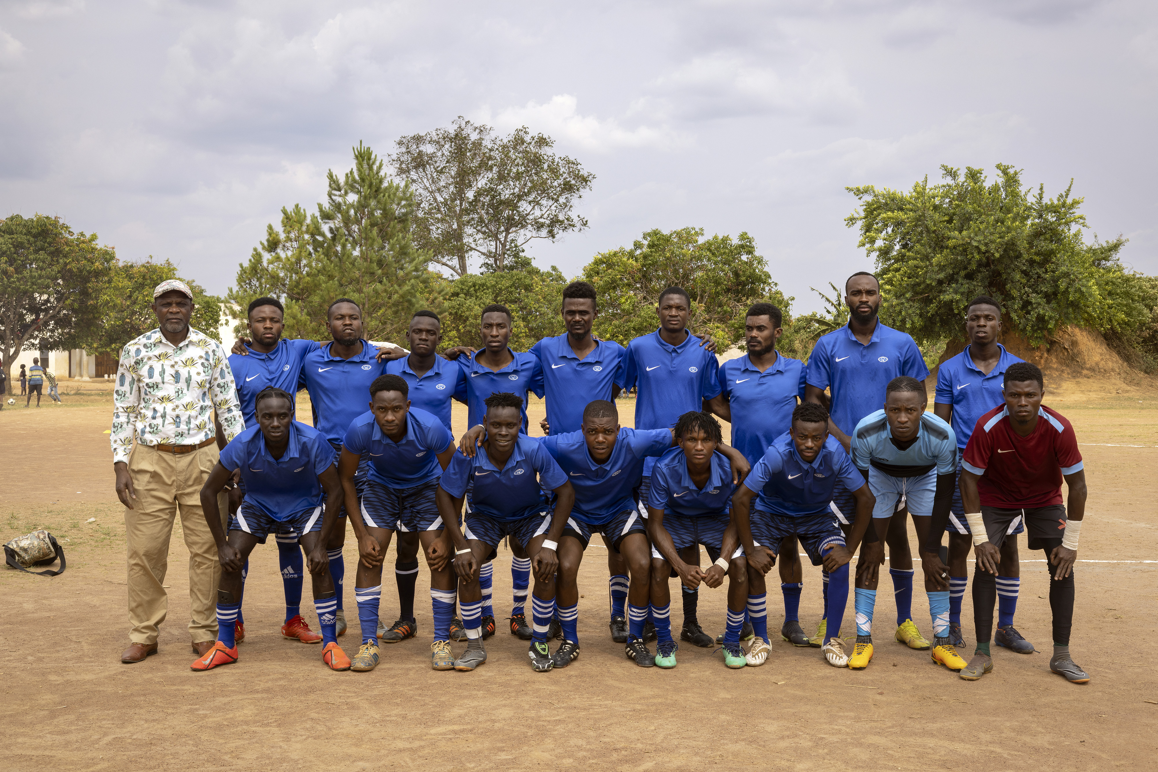 Football players on a field in a refugee camp in Zambia