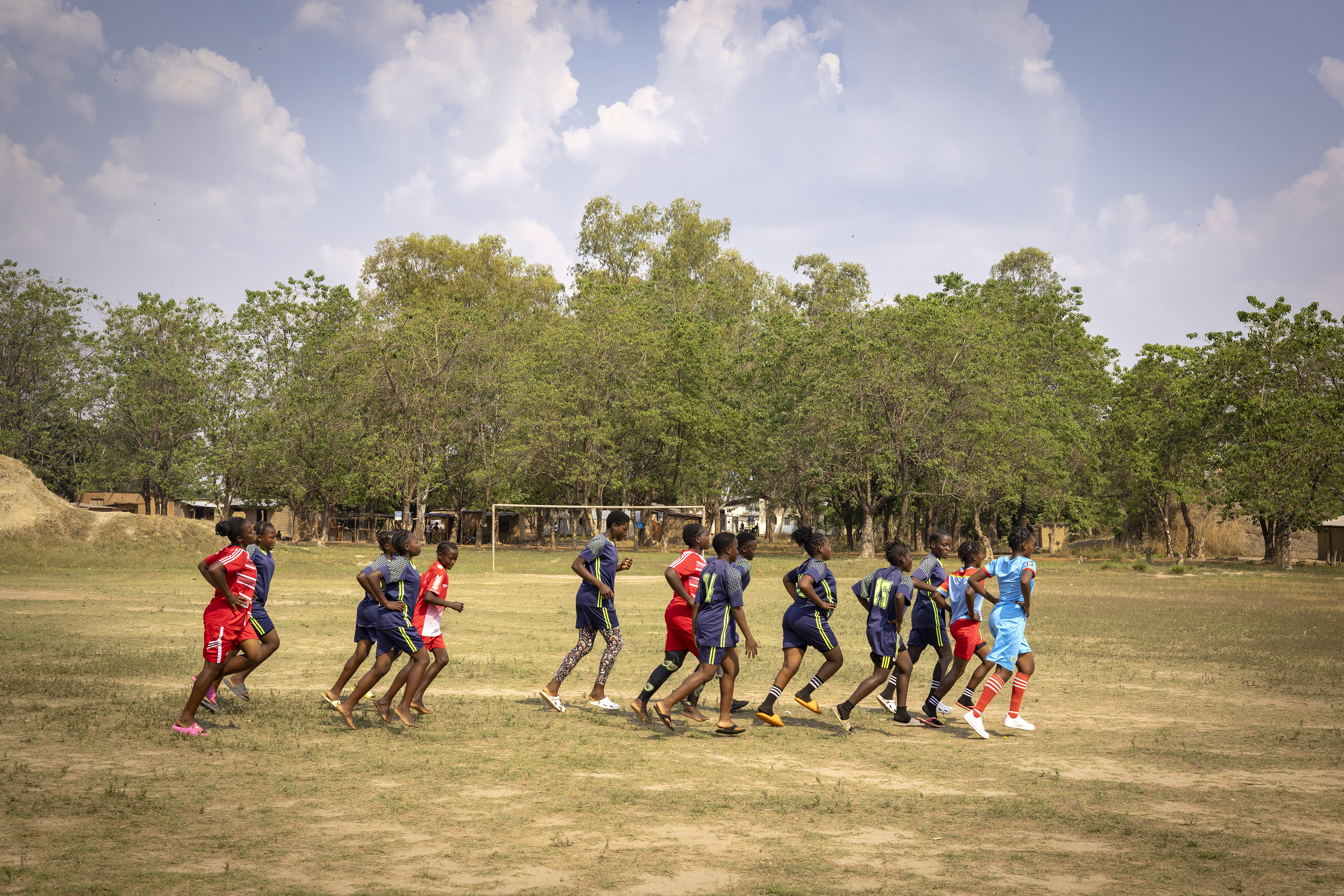 Football players train on a field in a refugee camp in Zambia
