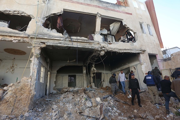 Palestinians inspect a destroyed house following a bombing by Israeli forces during 18-hour military operation on Jenin Refugee Camp in West Bank on November 29.