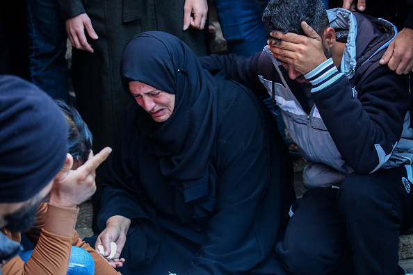People mourn as they collect the bodies of Palestinians killed in an airstrike on December 02, 2023 in Khan Yunis, Gaza.