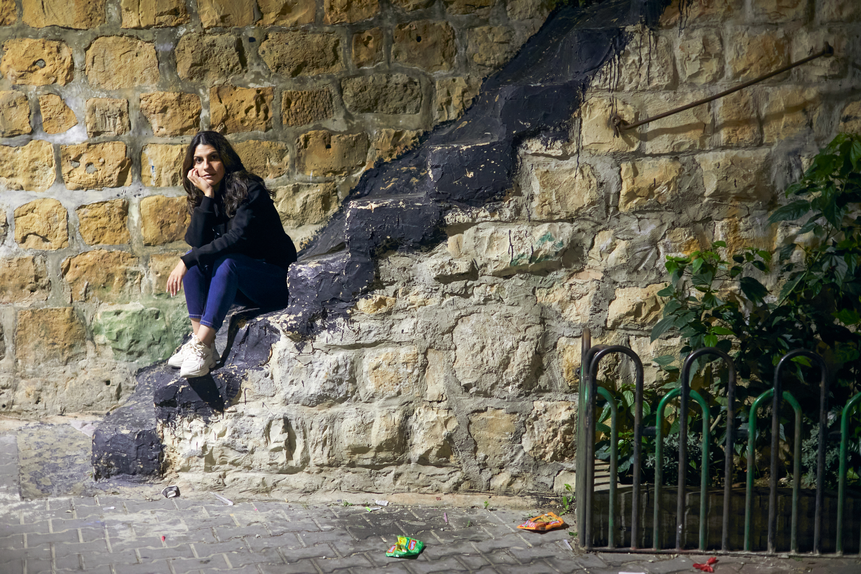 Nour sitting on stone steps