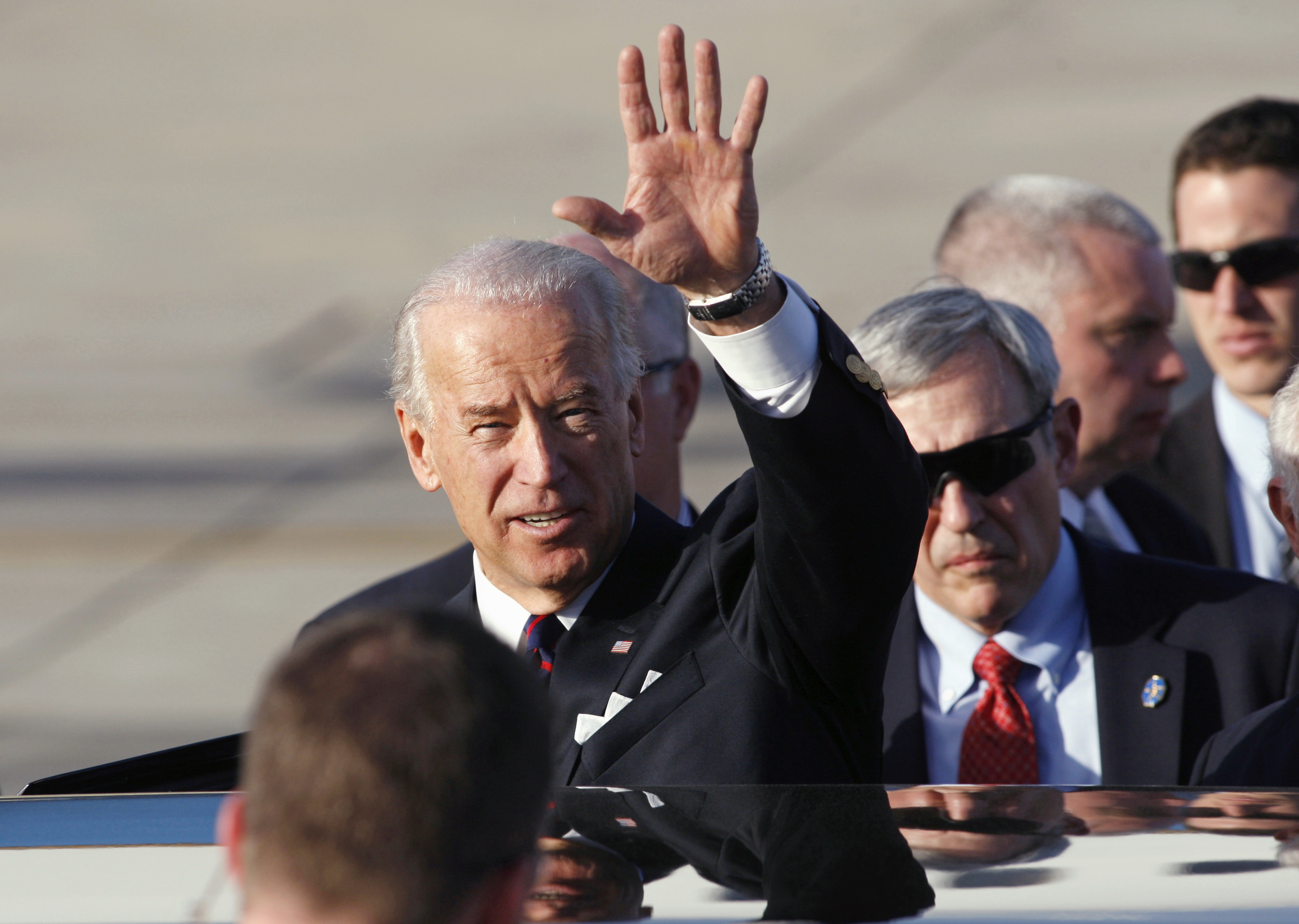 Biden waves as he gets into a car in Tel Aviv in 2010