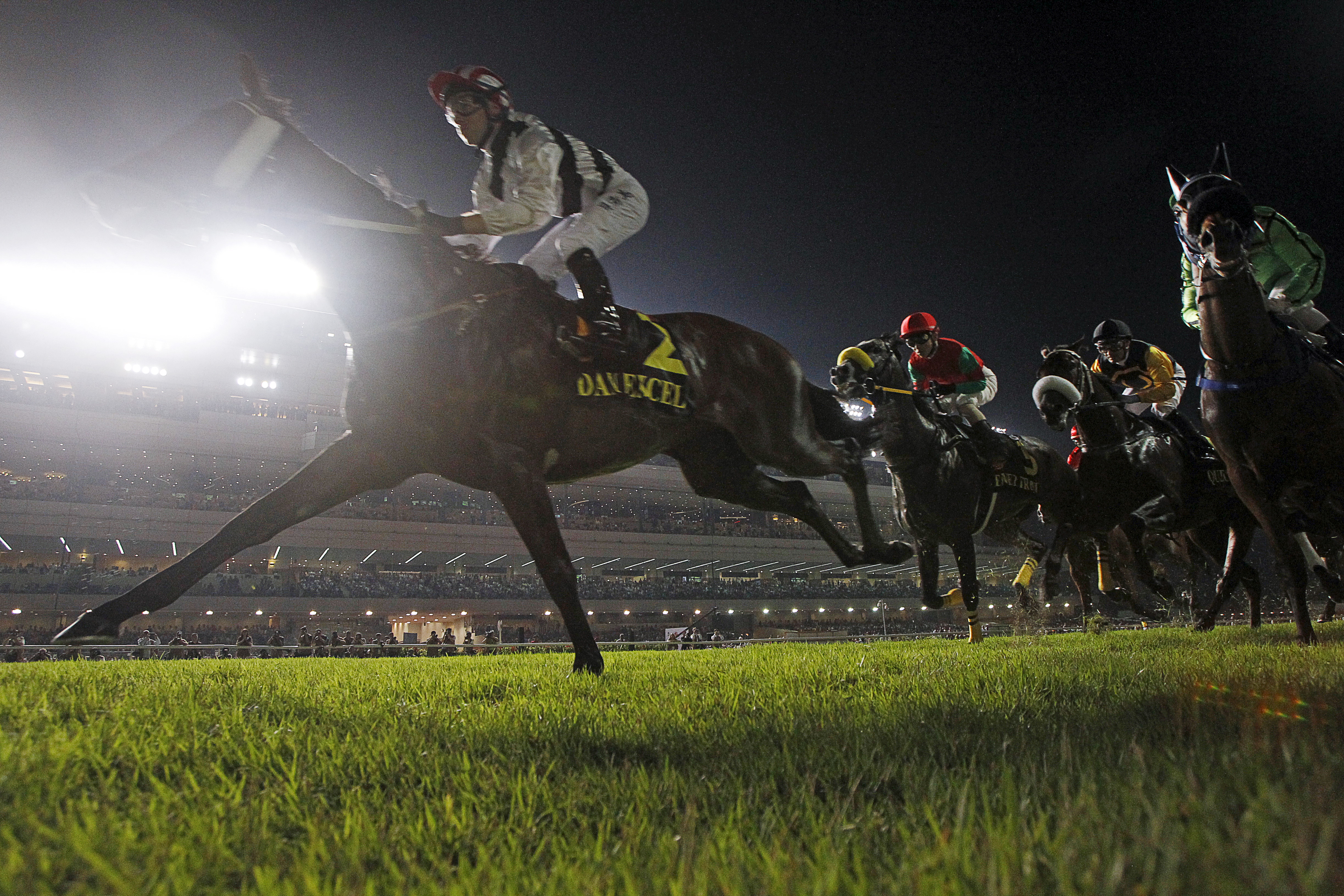 Dan Excel, a horse ridden by jockey Tommy Berry, heads to victory in a night race at the Singapore Turf Club
