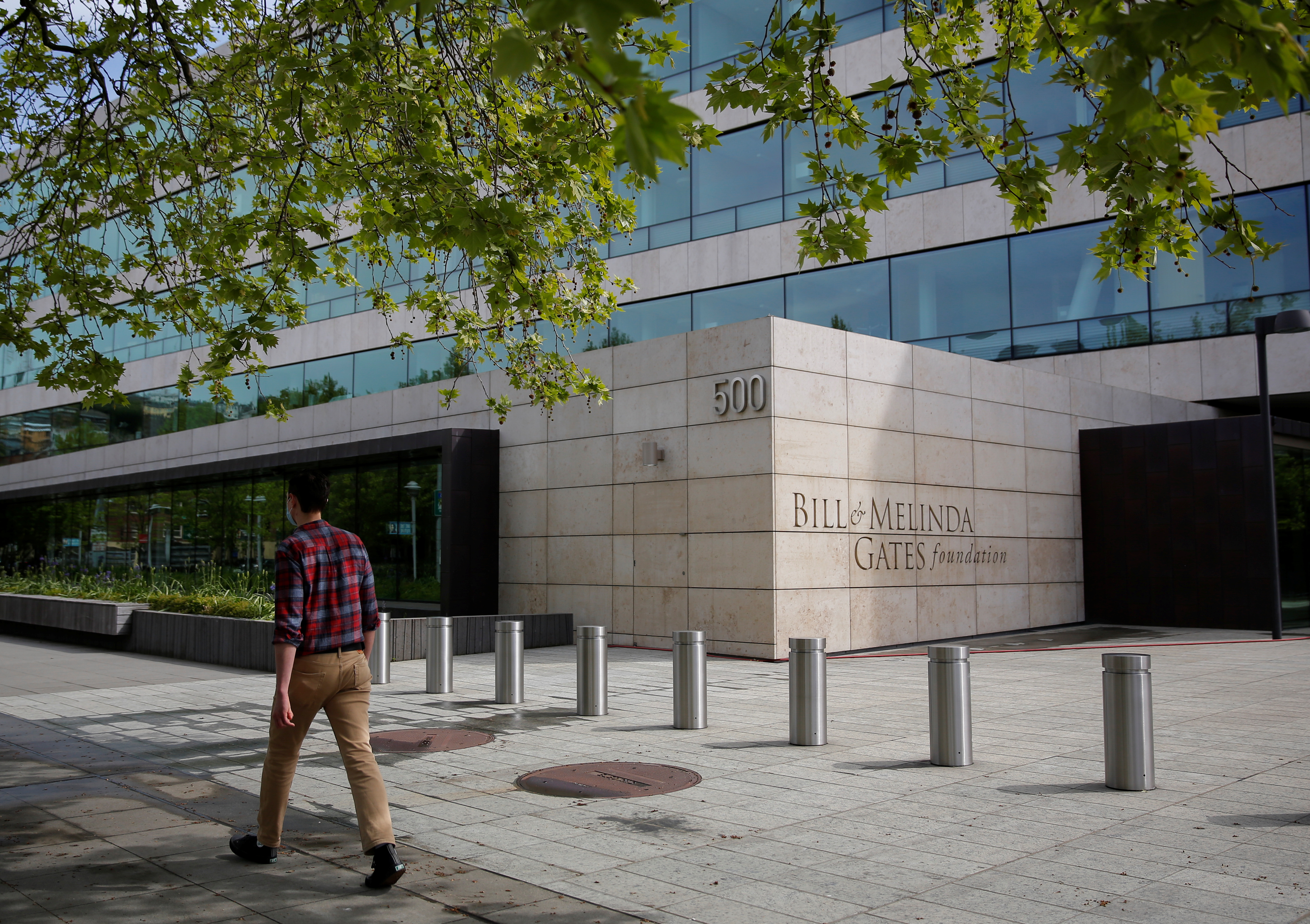 A pedestrian walks by the Bill & Melinda Gates Foundation in Seattle, Washington, U.S. May 5, 2021. REUTERS/Lindsey Wasson