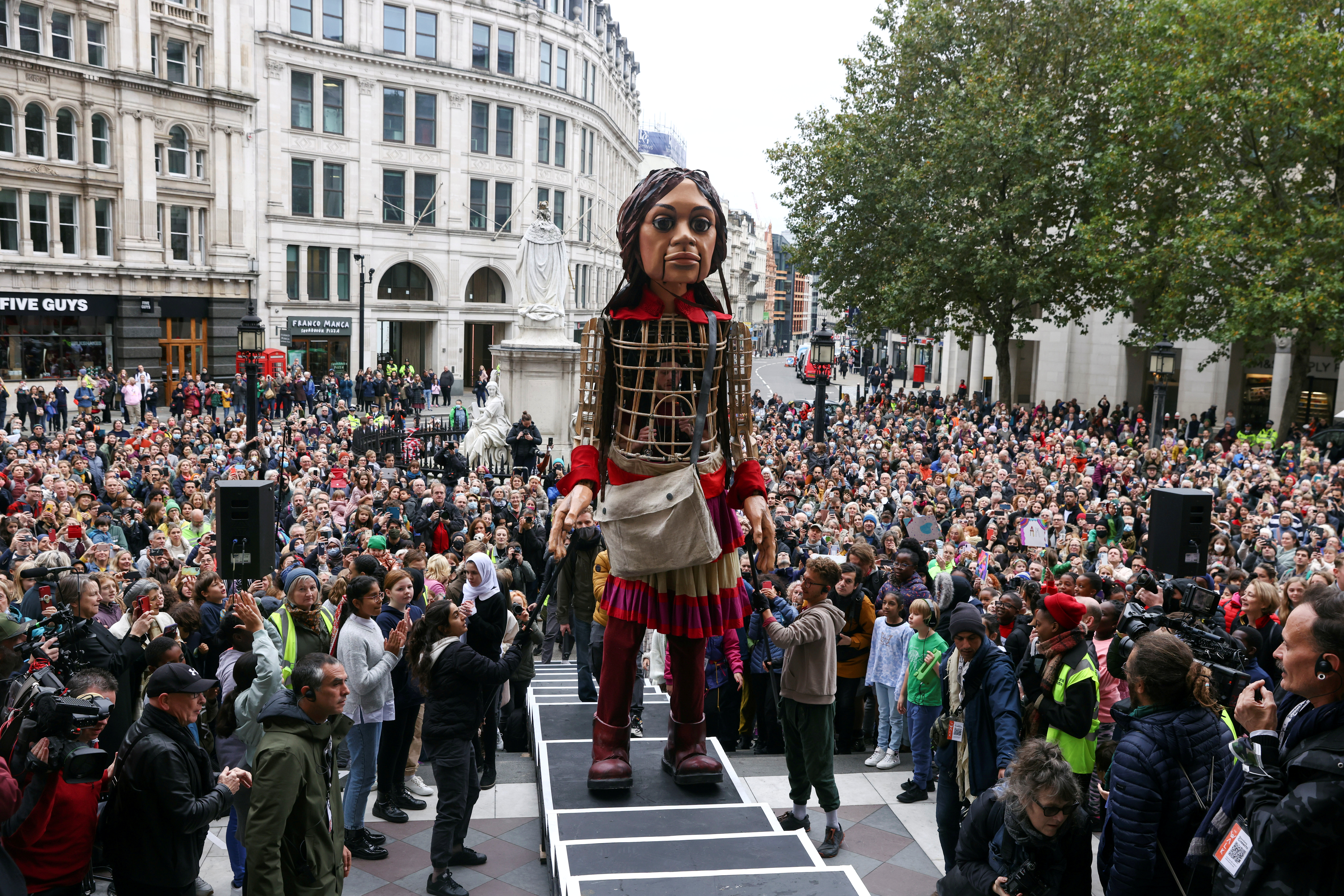 "Little Amal", a 3.5 metre tall puppet of a young Syrian refugee girl, arrives at St Paul's Cathedral, as part of its 8,000 km tour across Europe from Turkey to Britain to raise awareness for the plight of young refugees