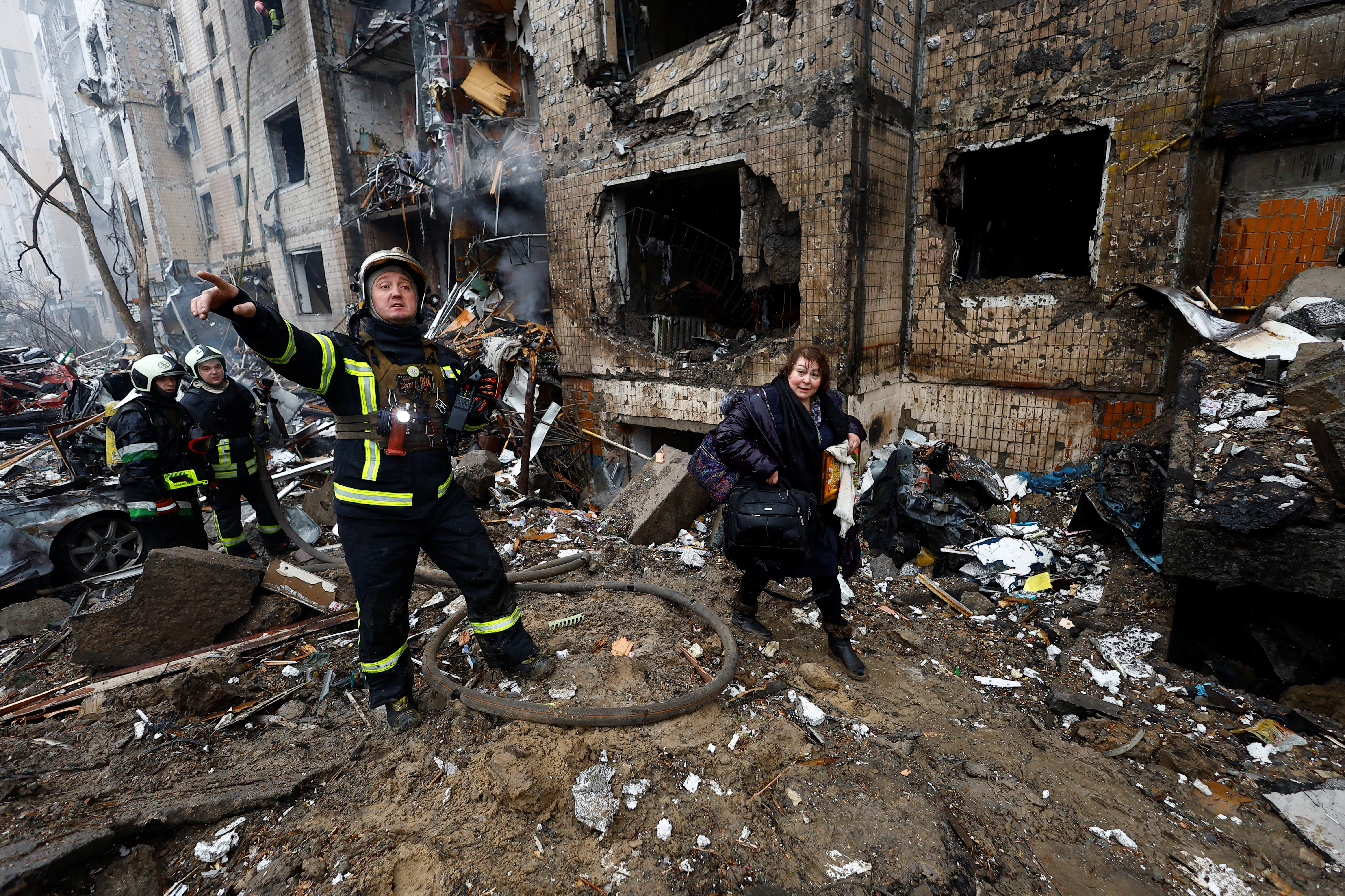 Firefighters work at a site of a residential building heavily damaged during a Russian missile attack, amid Russia's attack on Ukraine, in Kyiv,