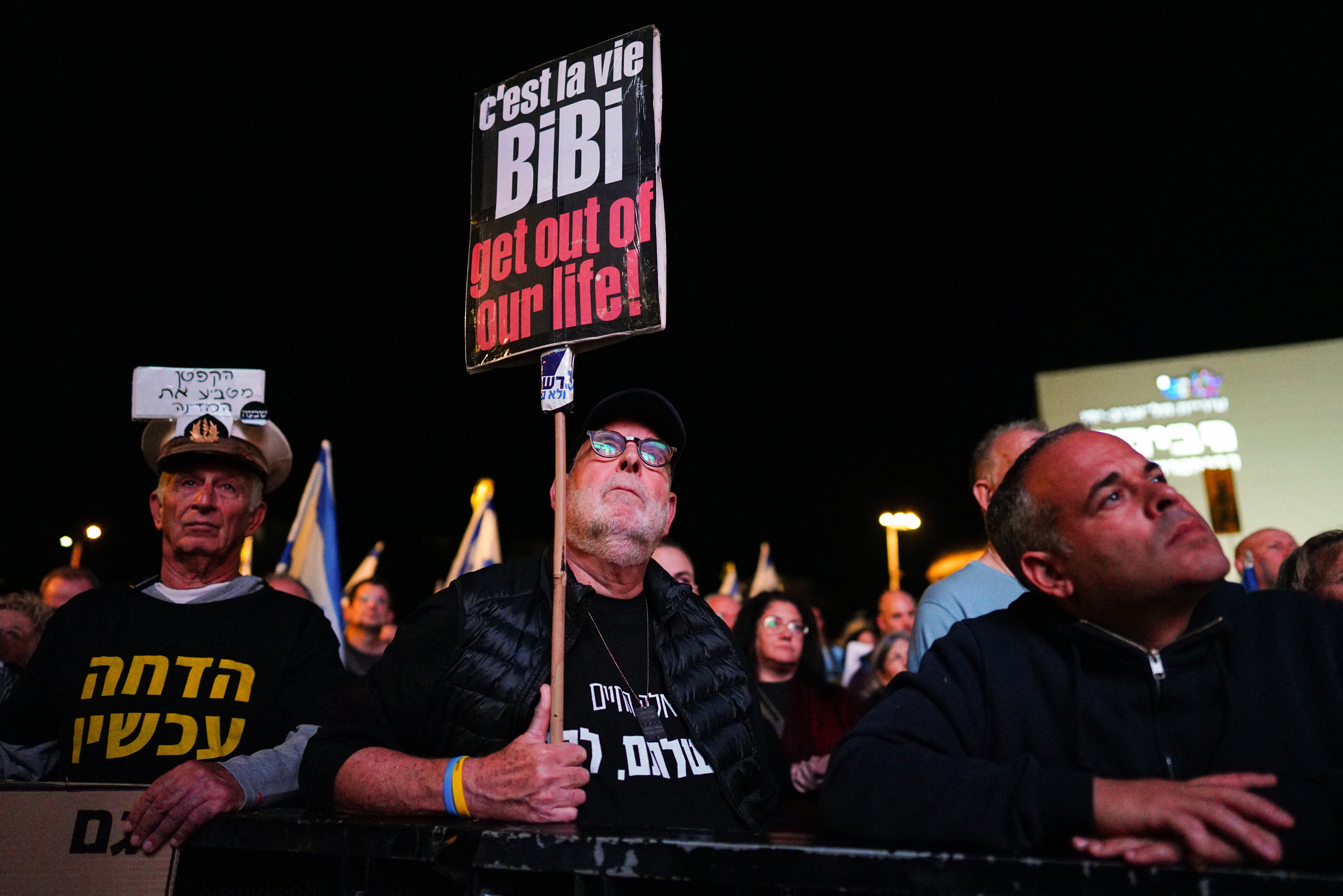 A man holds a placard during a demonstration against Israeli Prime Minister Benjamin Netanyahu's government in Tel Aviv, Israel, January 6