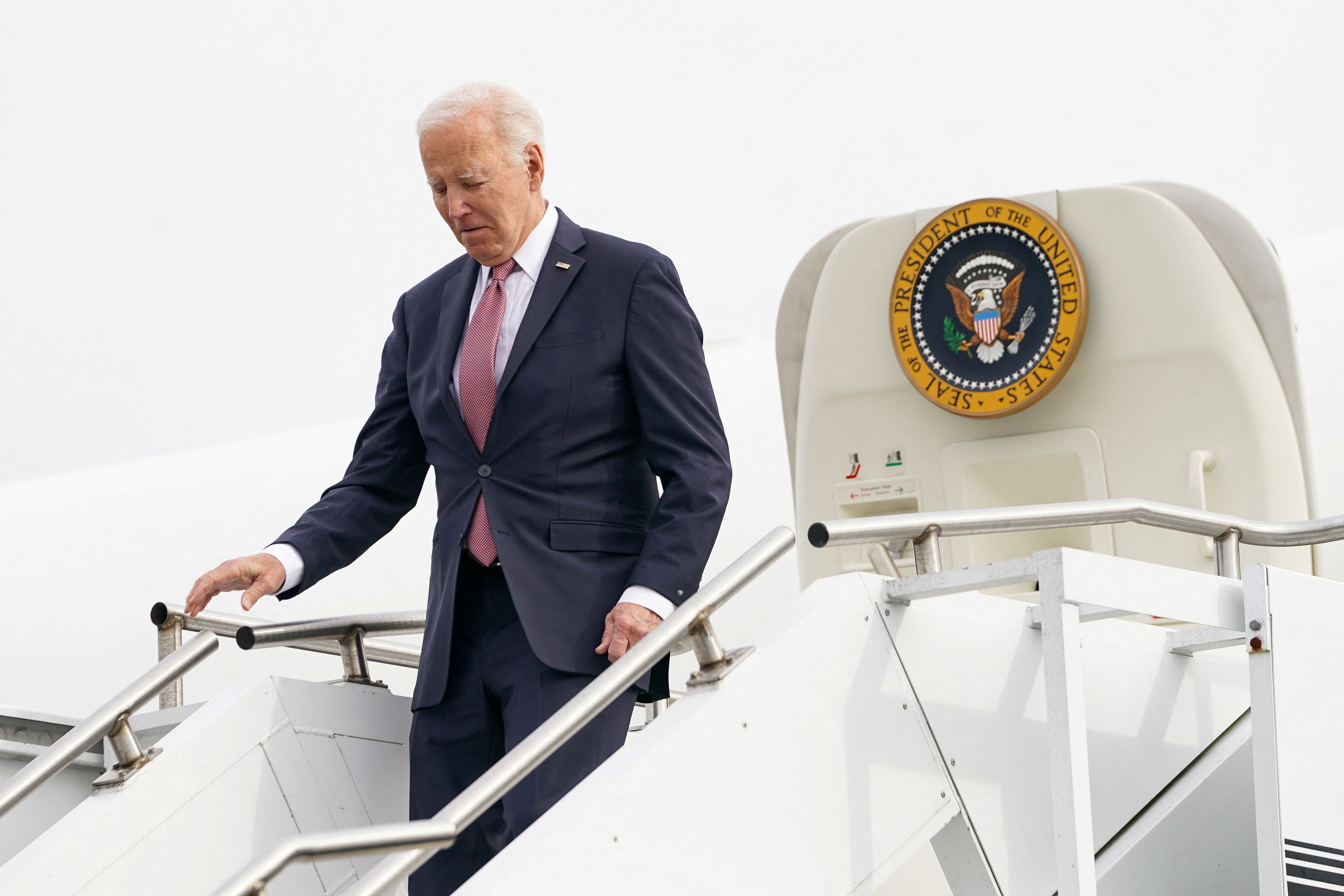 US President Biden walks down the steps of the Air Force One plane.