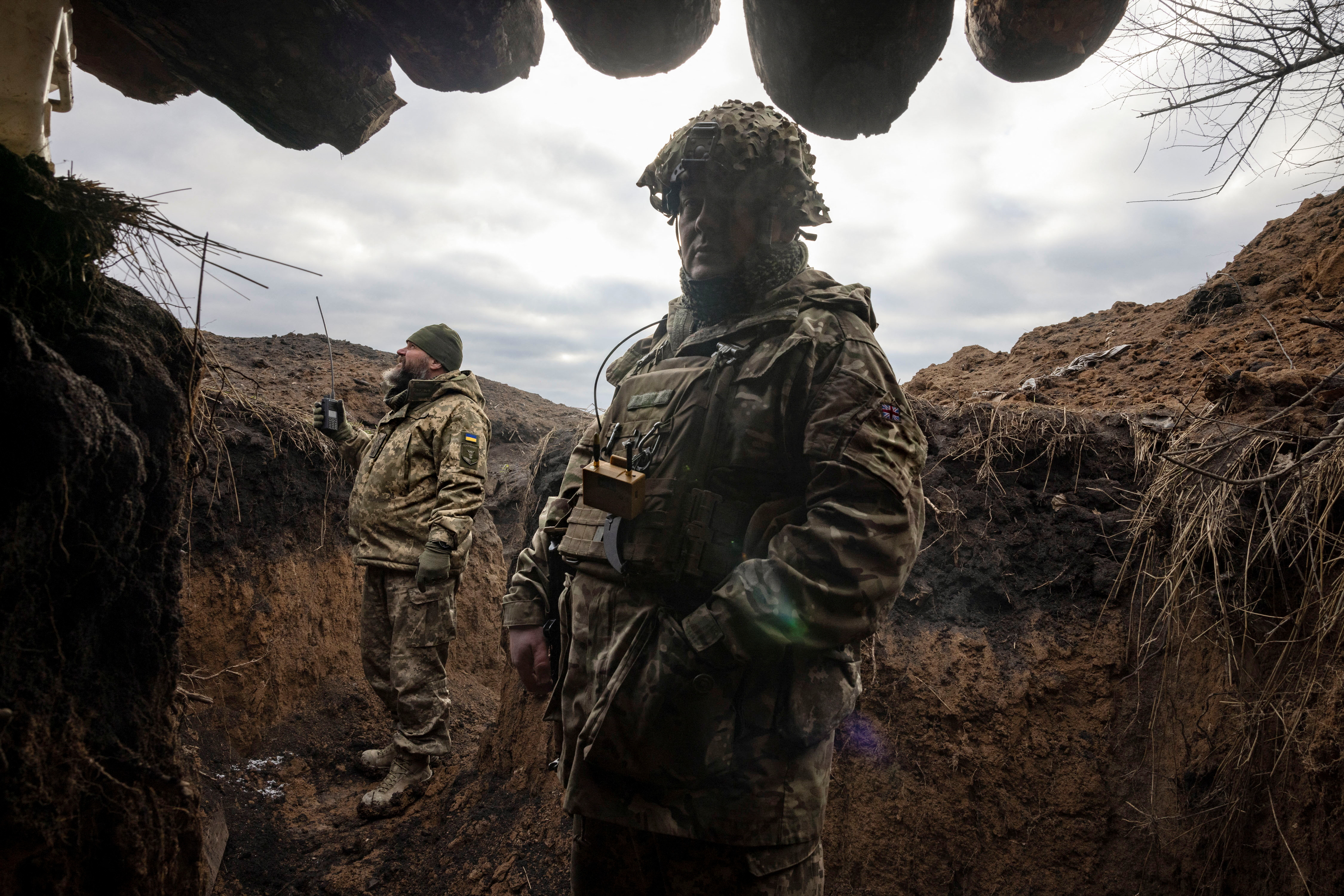 Ukrainian military engineers stand in a freshly dug trench that their unit built as part of a system of new fortifications near the front lines outside Kupiansk, amid Russia’s attack on Ukraine, December 28, 2023. REUTERS/Thomas Peter